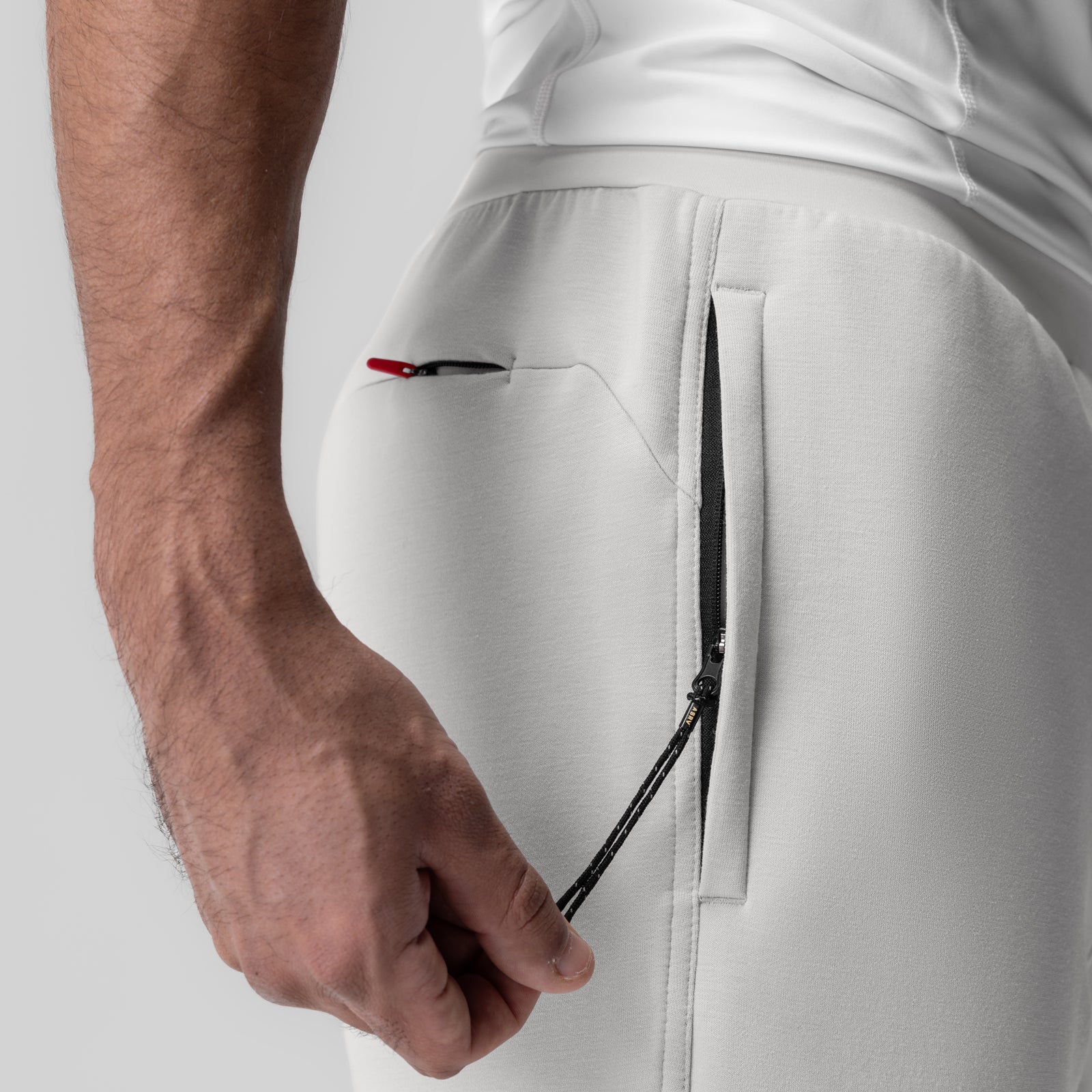 Dri-Core Training Jogger in light grey, worn by model showing side pocket detail