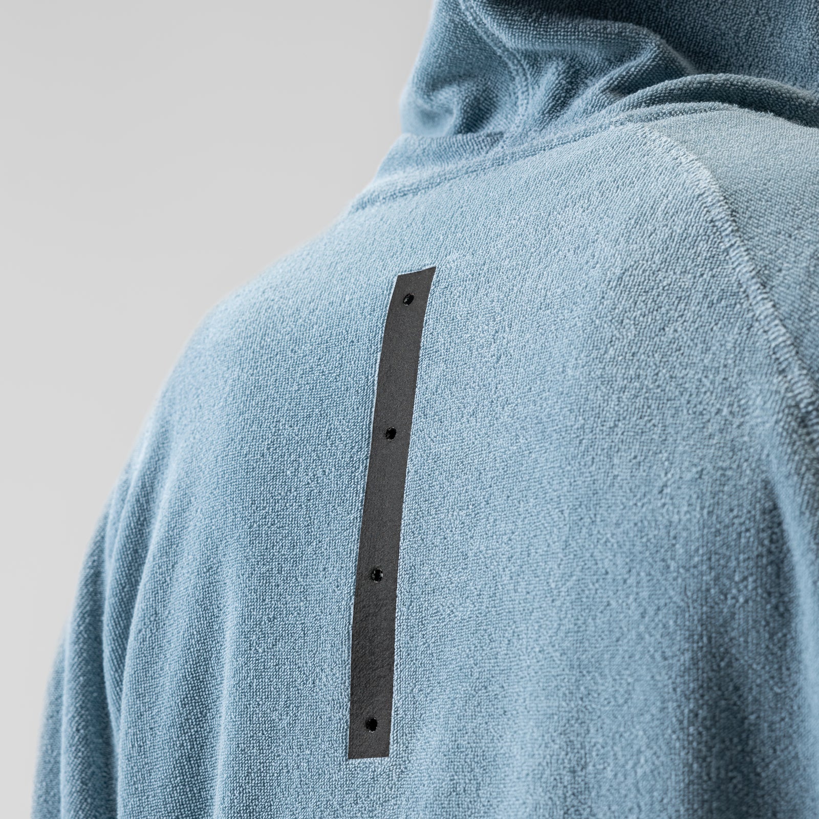 Towel Terry Reversible Hoodie in Light Sky worn by model, back view showing detail strip