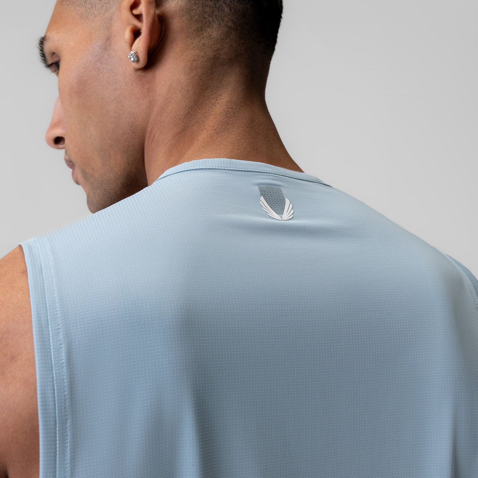 Ice-Skin™ Muscle Tank in Light Sky, worn by model shown from back angle
