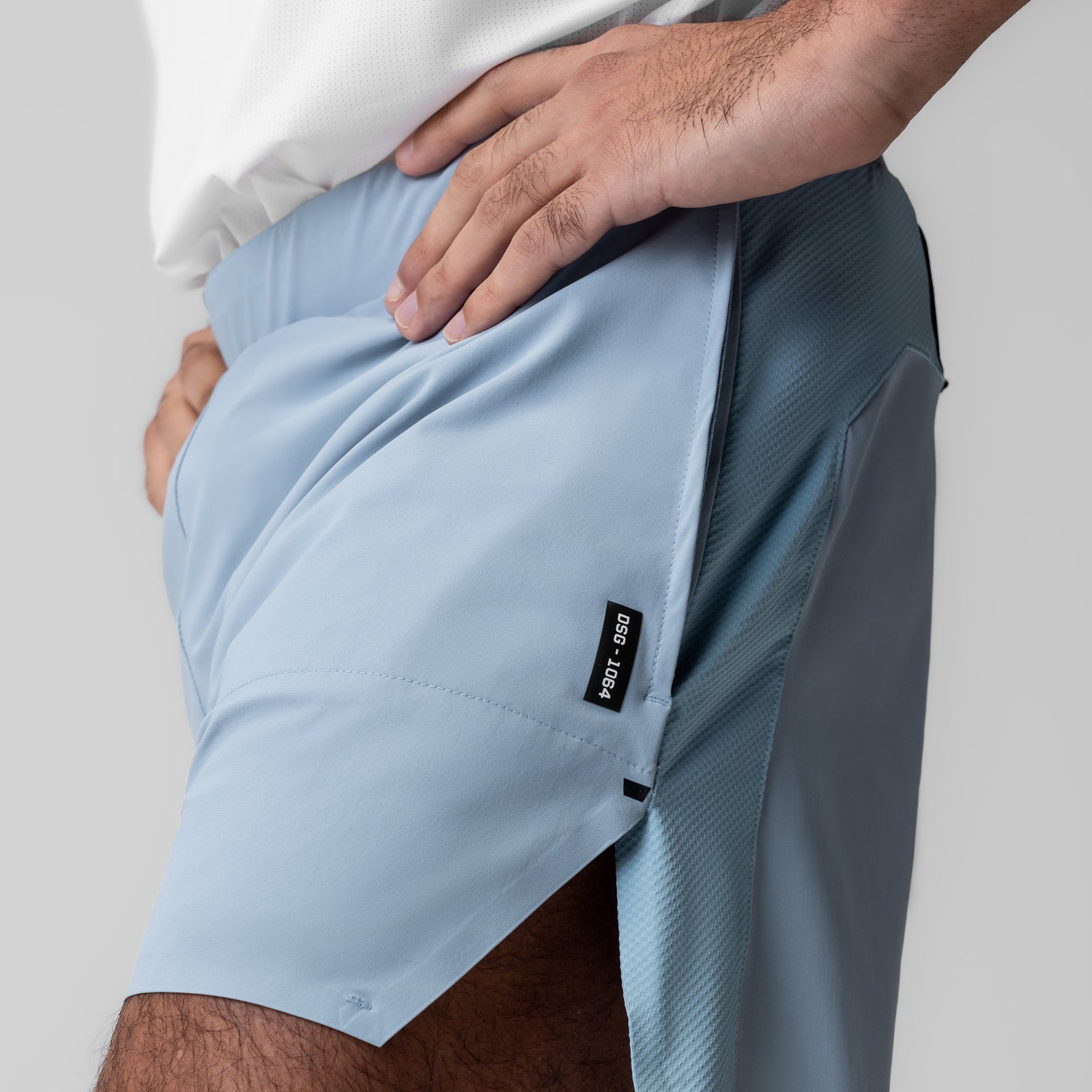 Tetra-Lite 6" Bonded Training Short in light sky, worn with side pocket detail