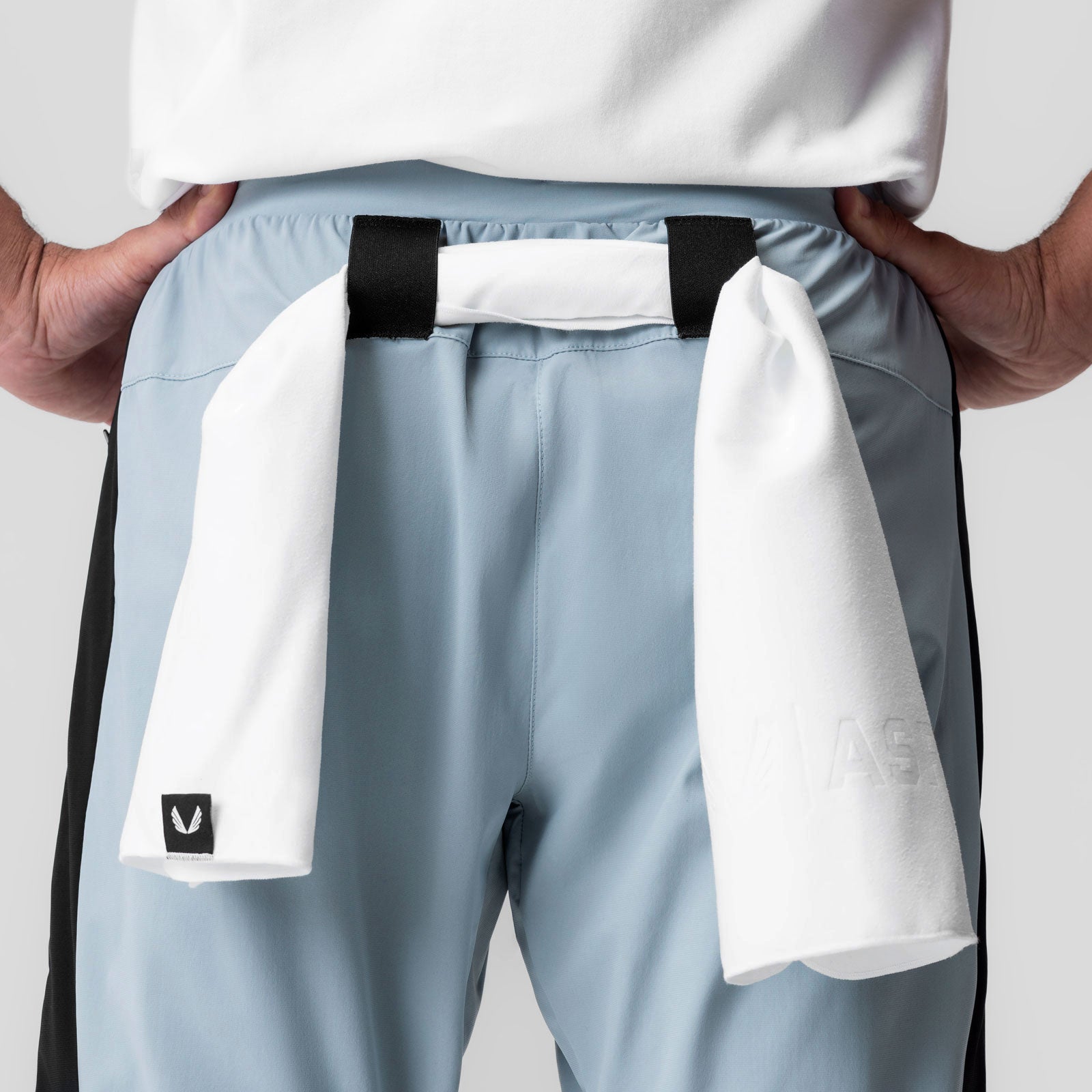 Tetra-Lite Cuffed Training Jogger in light sky, worn with white towel draped over shoulders