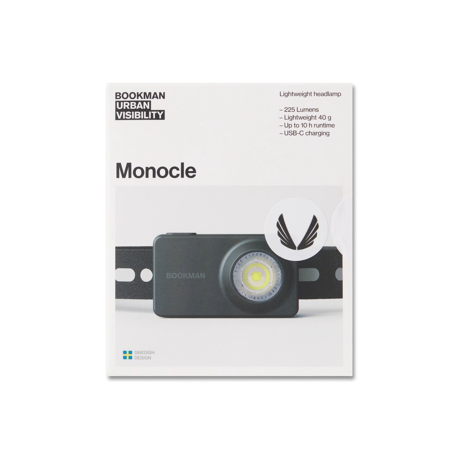 Flatlay of Bookman Monocle headlamp in black with silver accent, front view