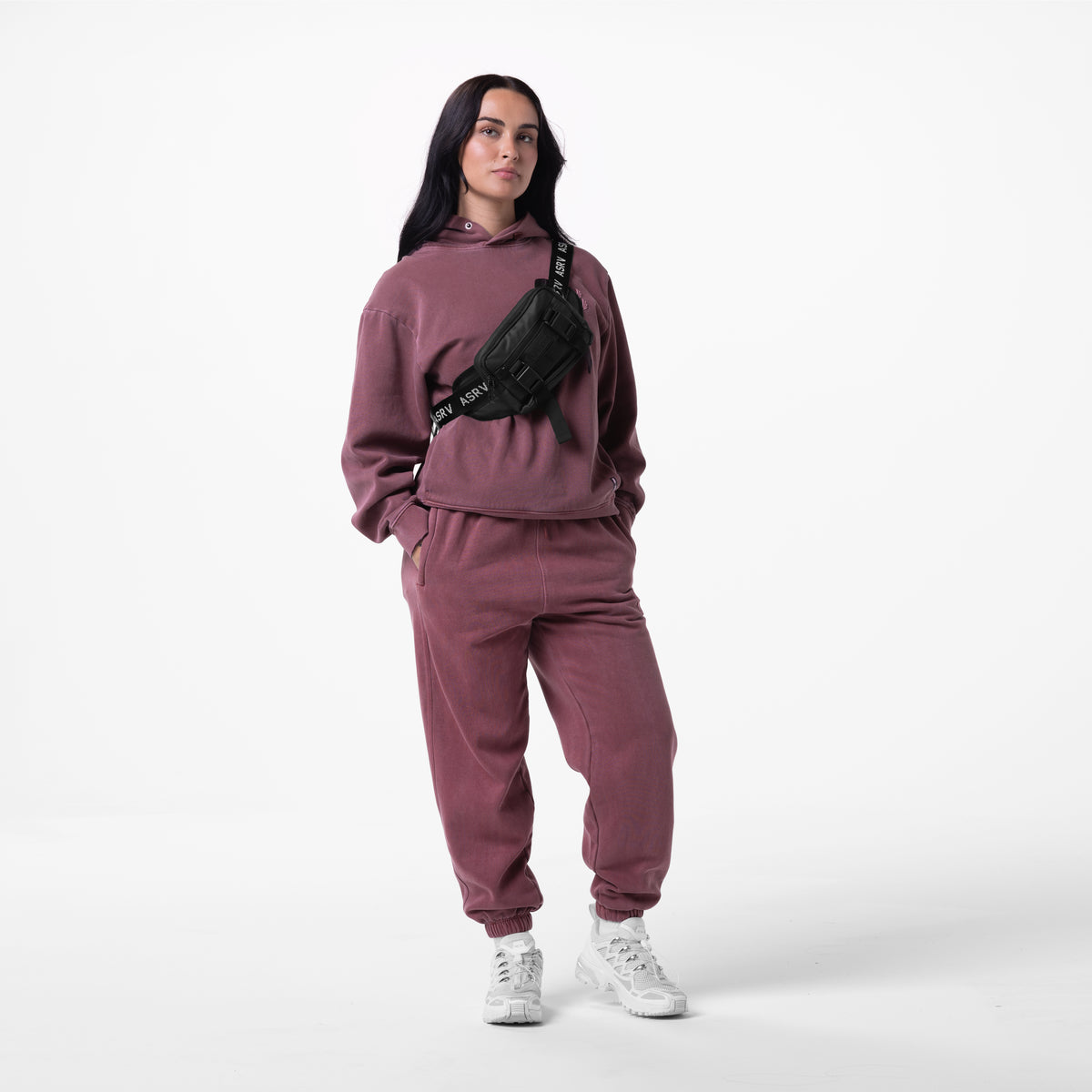 Tech Essential™ Sweats in Faded Crimson worn with matching hoodie and black waist bag