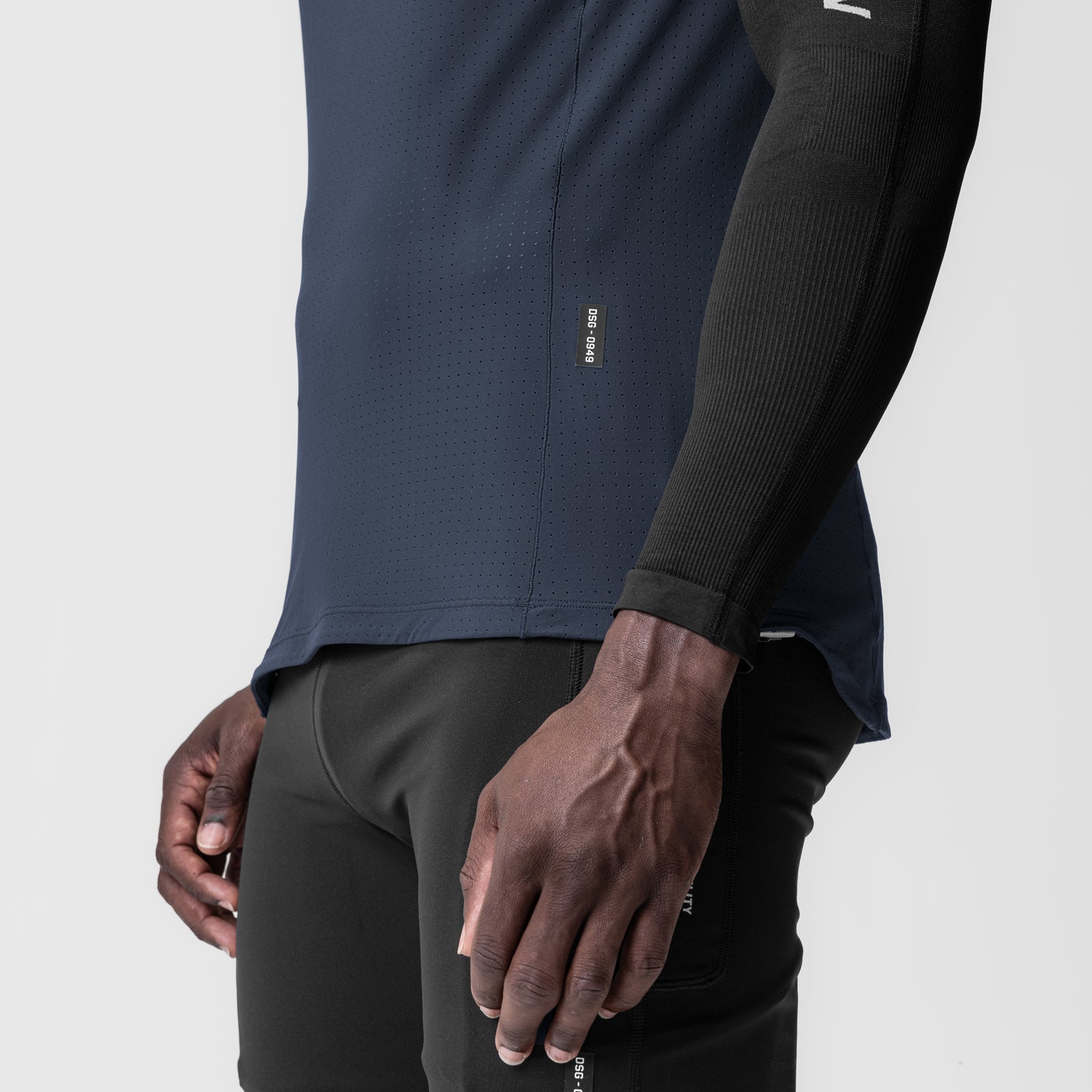 Laser-Vent™ Singlet Tank in navy worn by model, side view showing perforated fabric detail