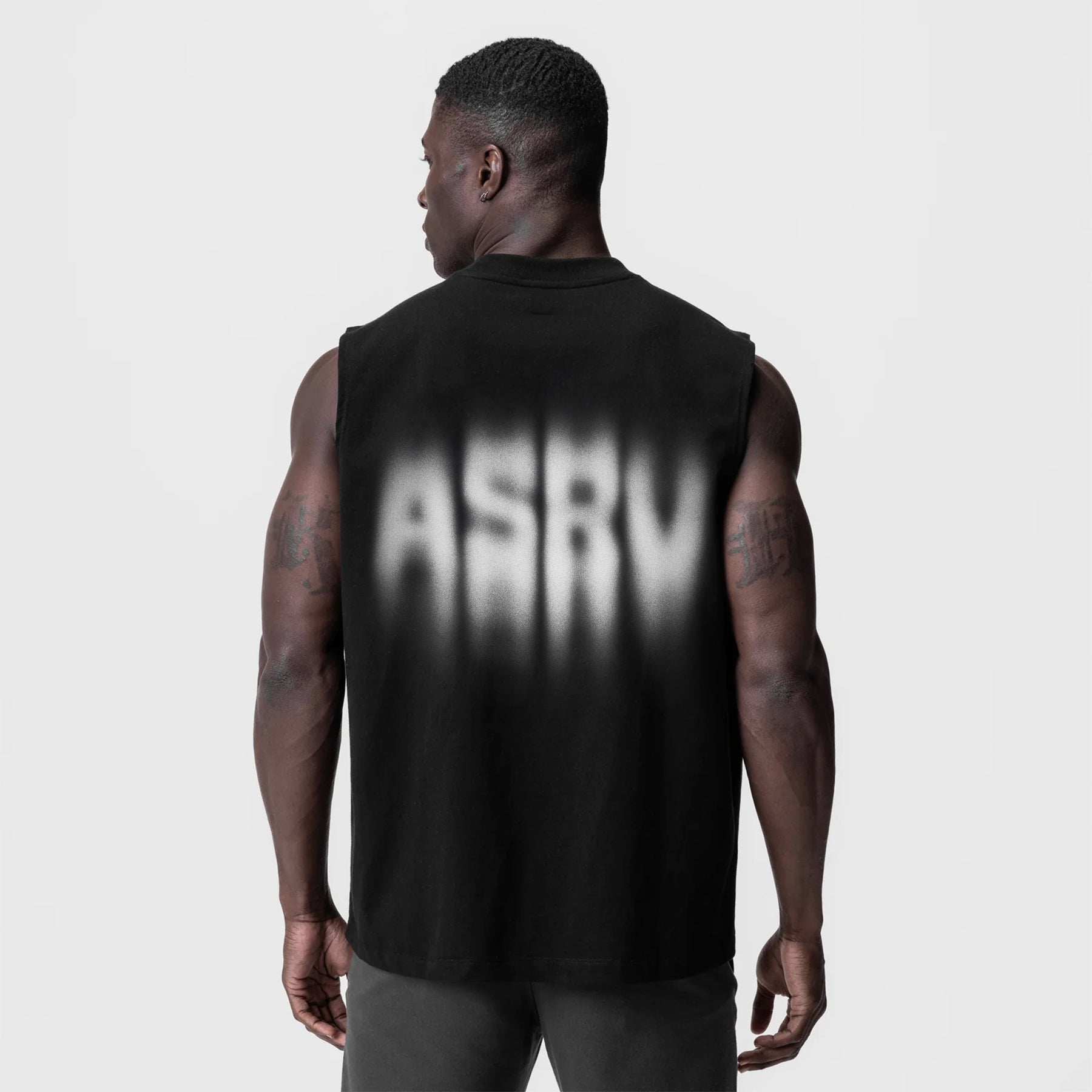 Tech Essential Relaxed Cutoff sleeveless tank in black with motion blur graphic, back view on model