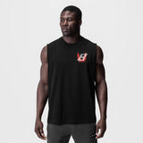 Black Tech Essential Relaxed Cutoff tank top with red logo, worn by model, front view