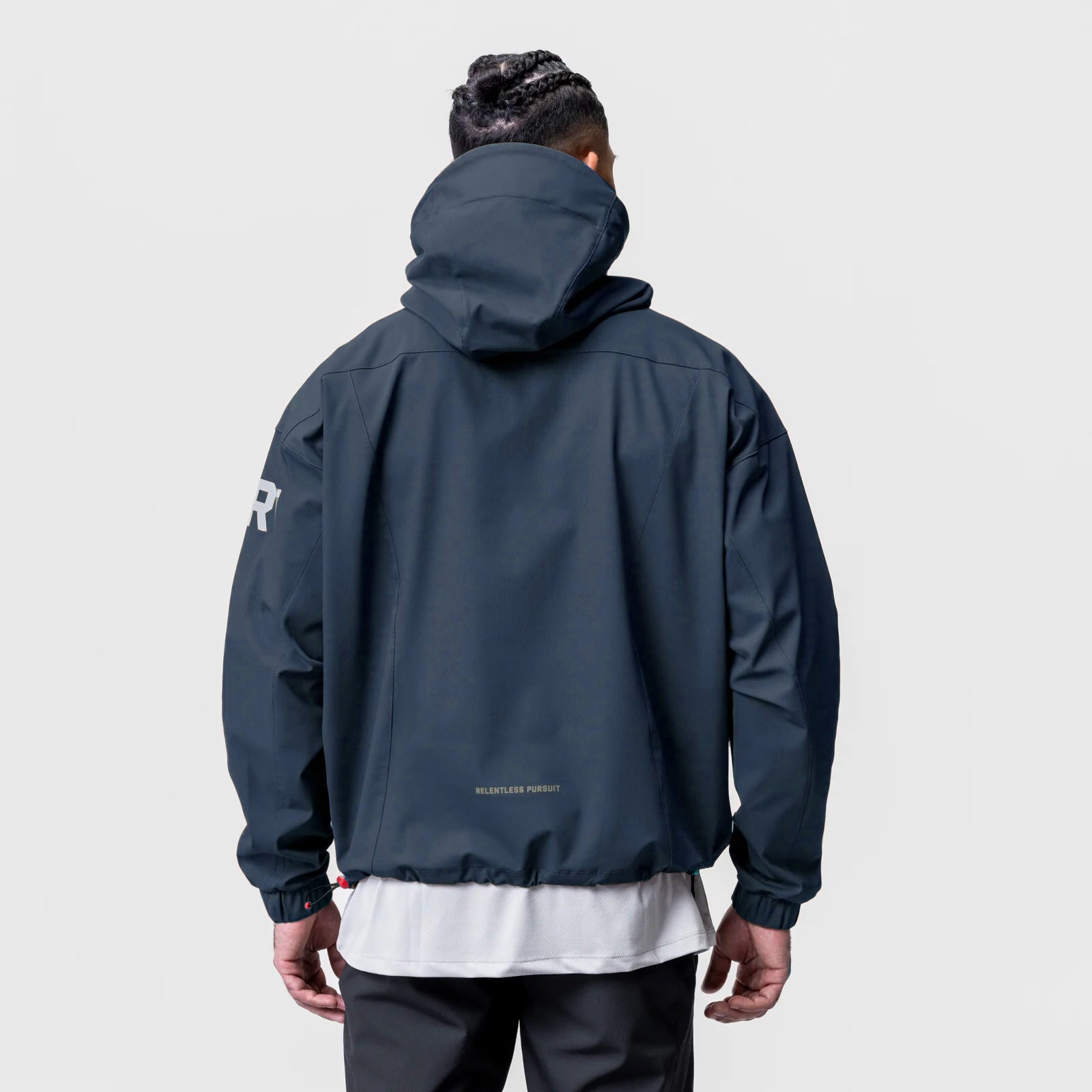 Navy weather-ready anorak jacket worn by model, back view
