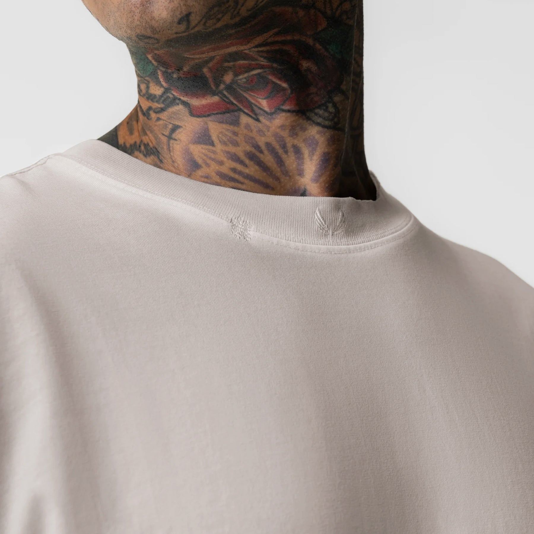 Tech Essential Relaxed Tee in Faded Chai worn by model, close-up of neckline and shoulders