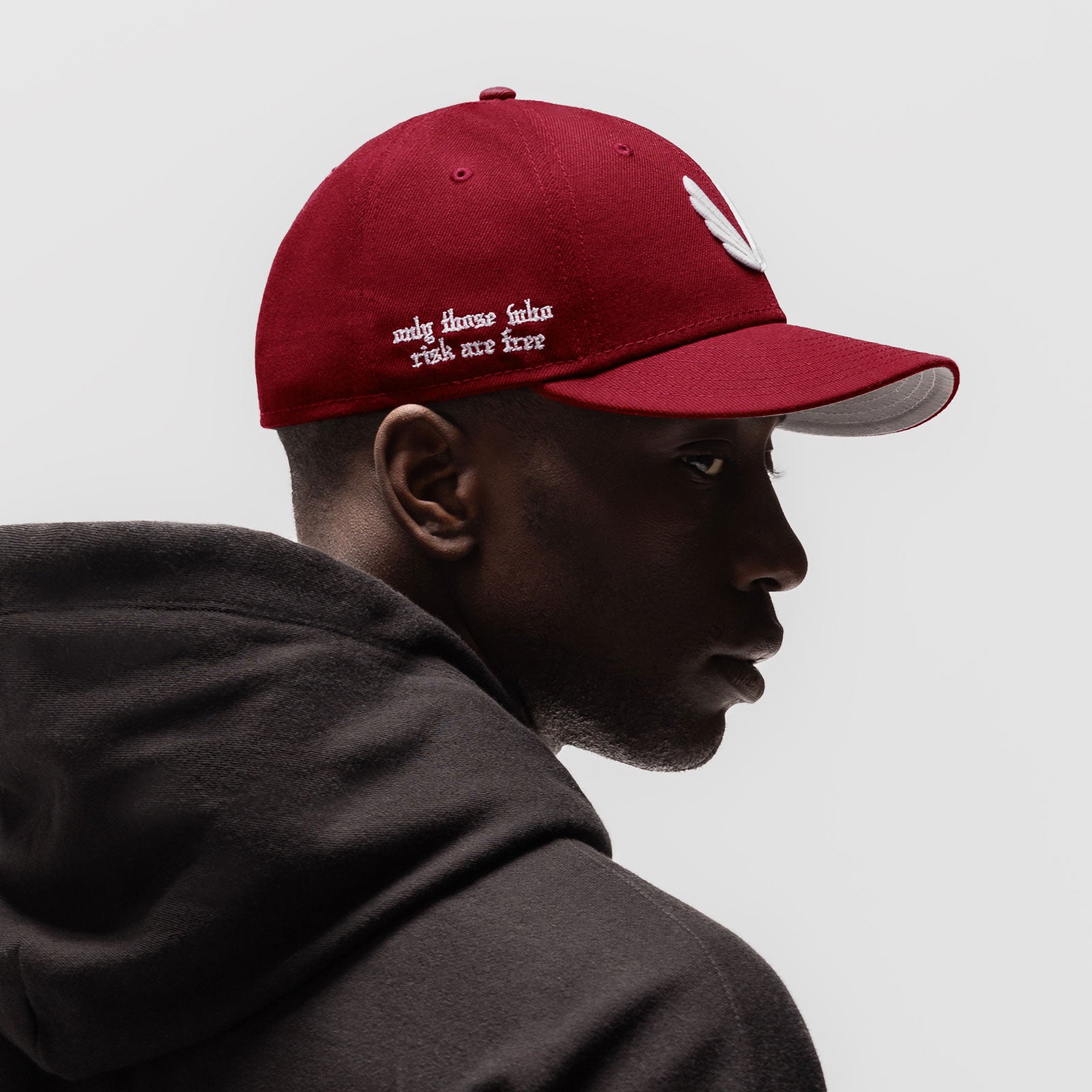 New Era 59Fifty Low Profile Hat in crimson with white wings logo, worn by model in profile