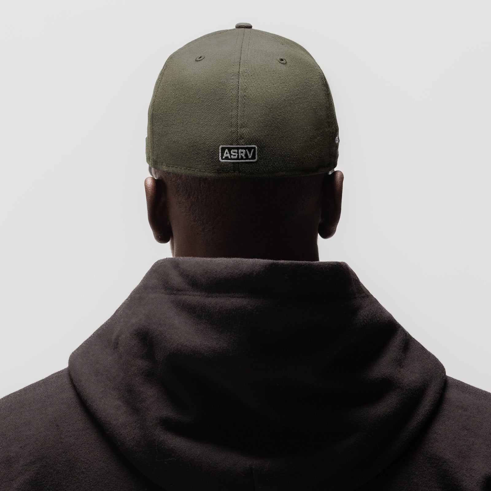 New Era 59Fifty Low Profile Hat in faded olive, worn from back view with model