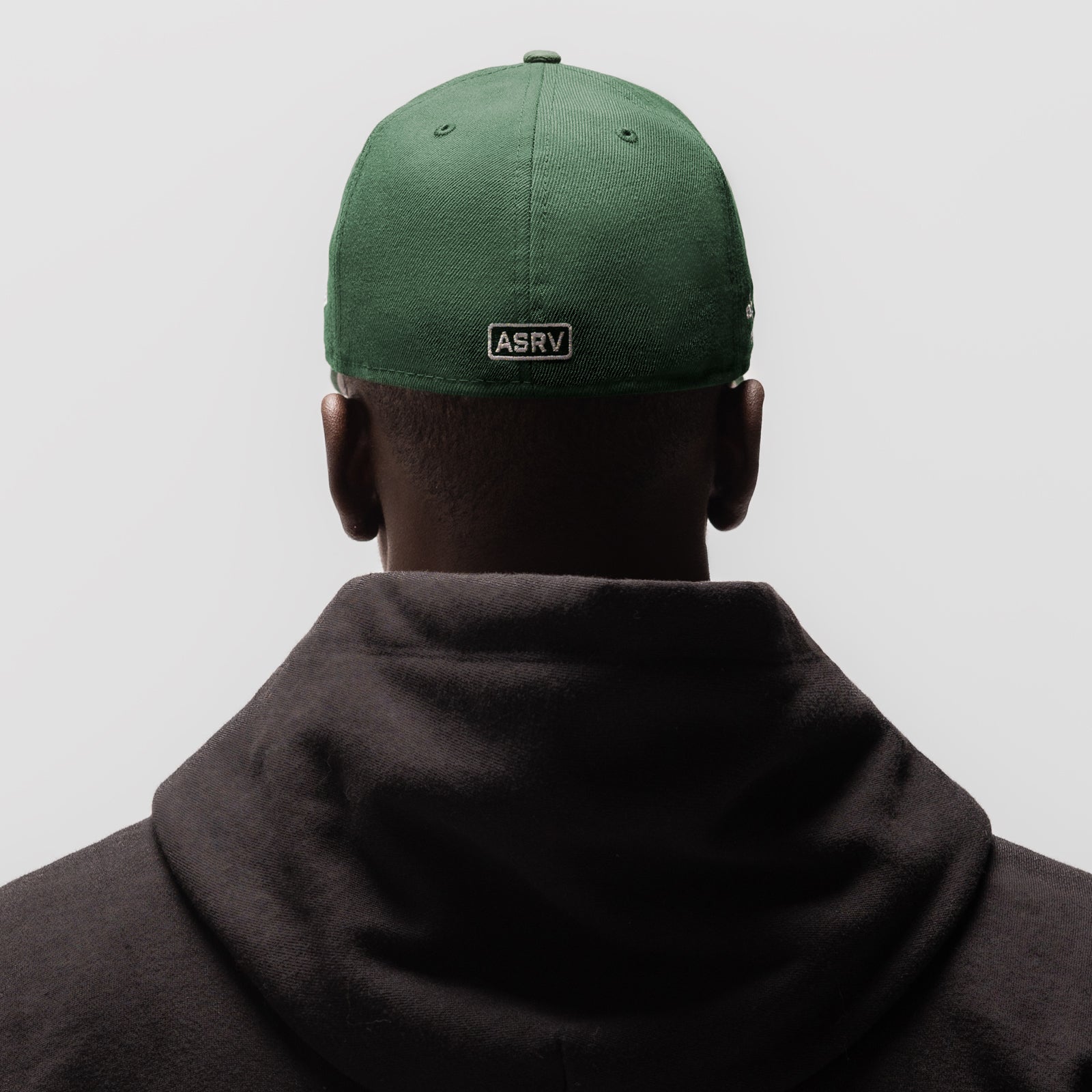 New Era 59Fifty Low Profile Hat in forest green, worn on model from back view