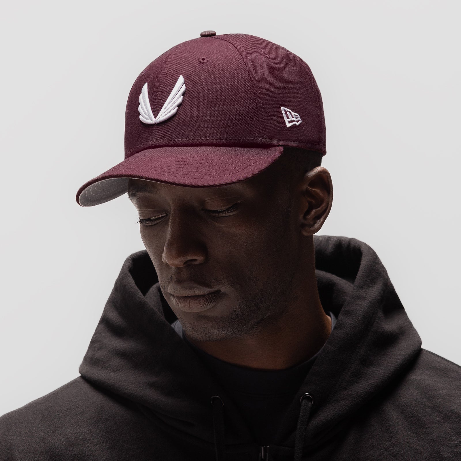 New Era 59Fifty Low Profile Hat in maroon with white wings logo, worn by model