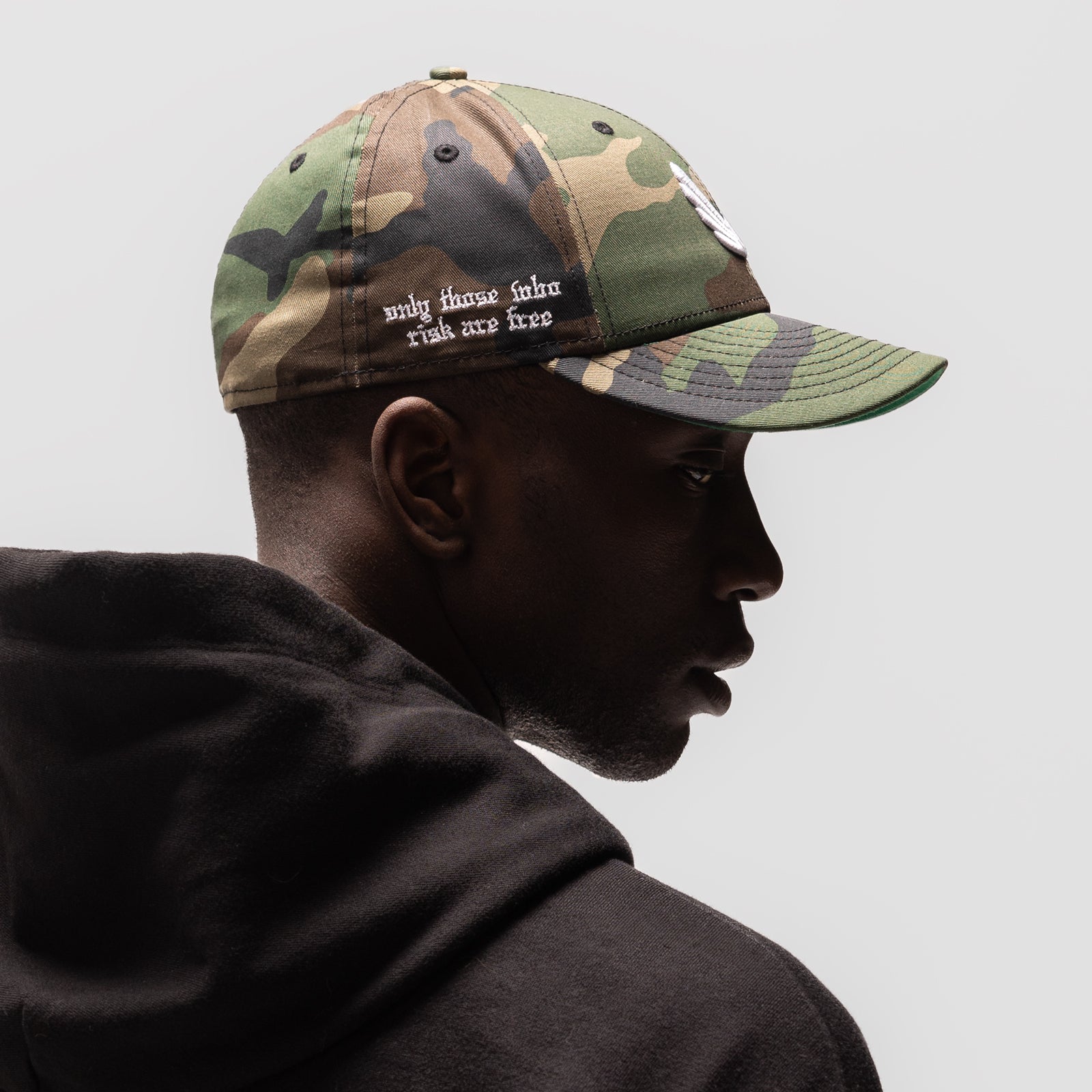 New Era 59Fifty Low Profile Hat in Woodland Camo/White, worn by model in profile view