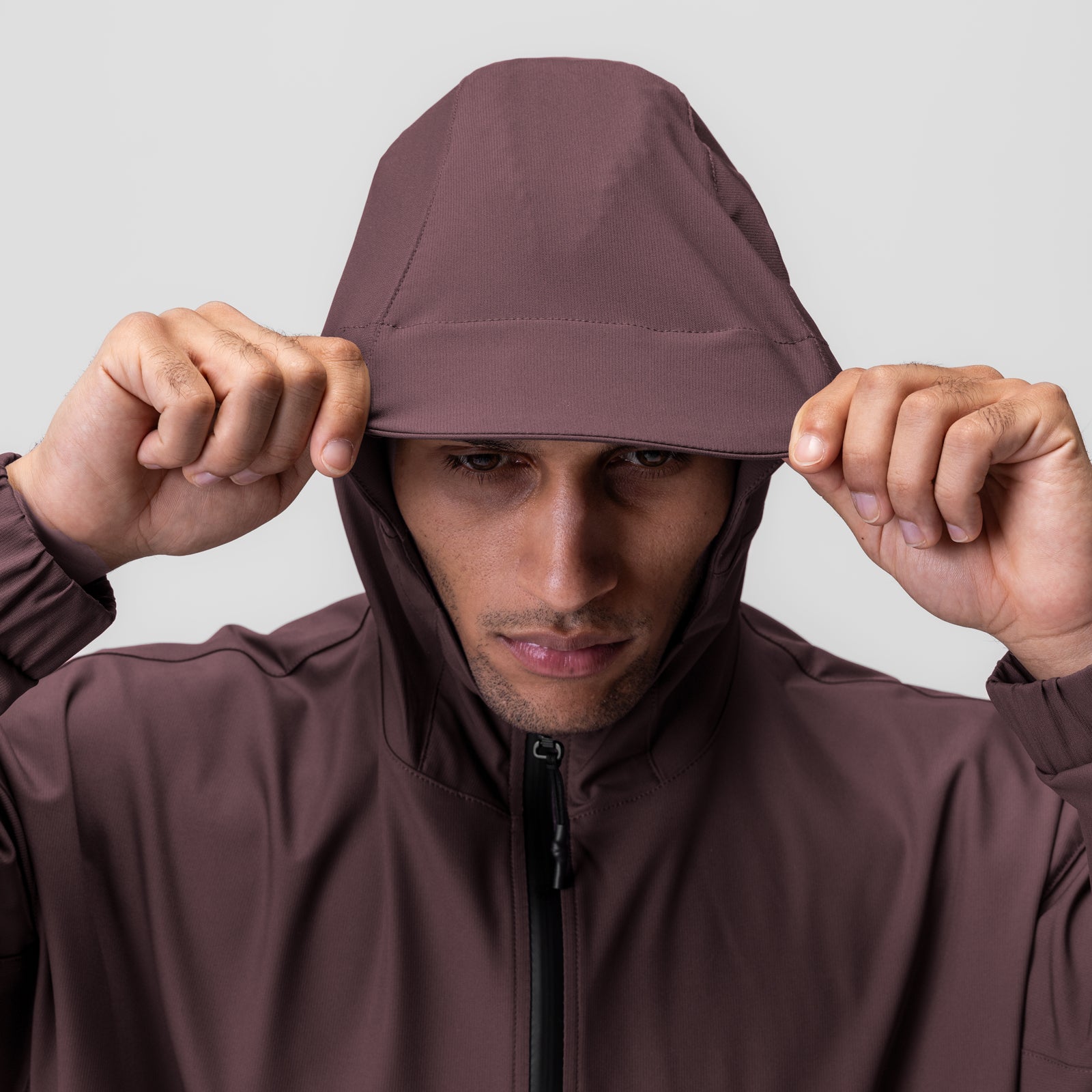 Weather-Ready Anorak Jacket in nightshade worn by model pulling hood down, front view