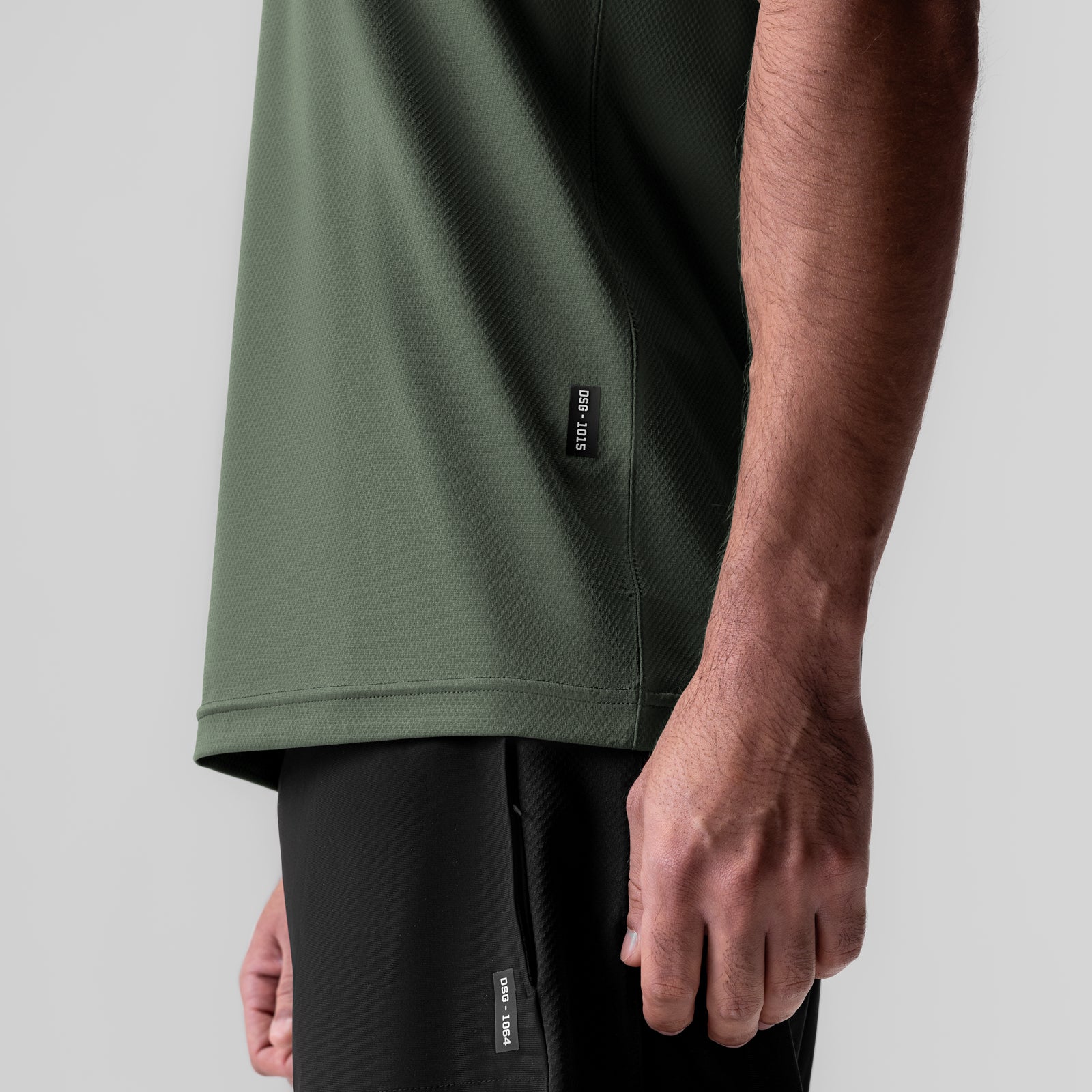 AeroSilver Essential Tee in olive, worn by model showing side view and fit