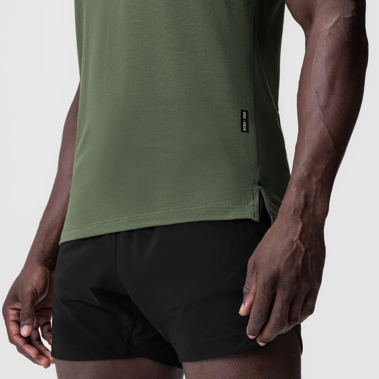 Supima Fitted Tee in olive green worn with black shorts, side view on model