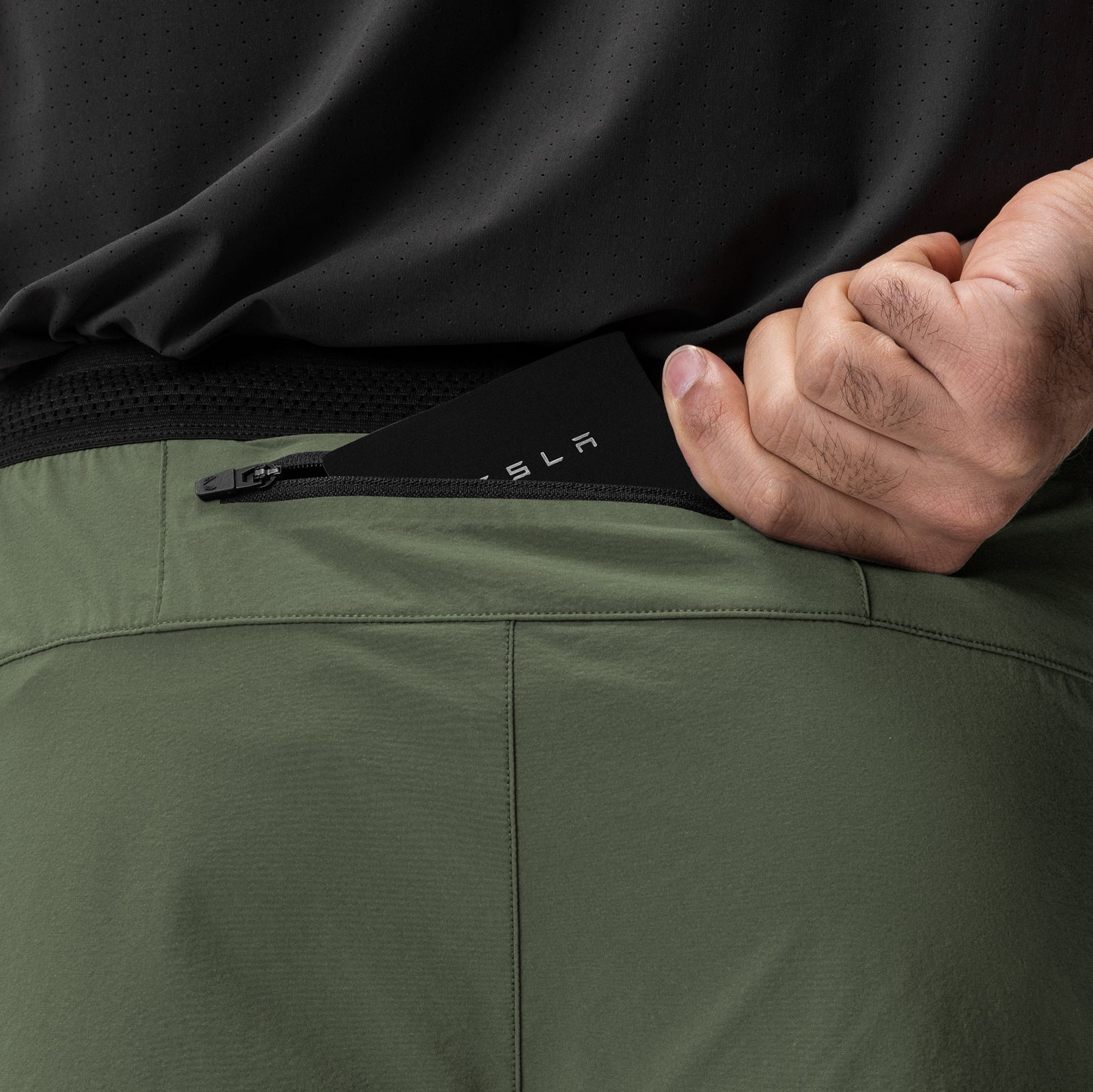Aerotex Hybrid Liner Short in olive and black, model detail shot of waistband and zipper