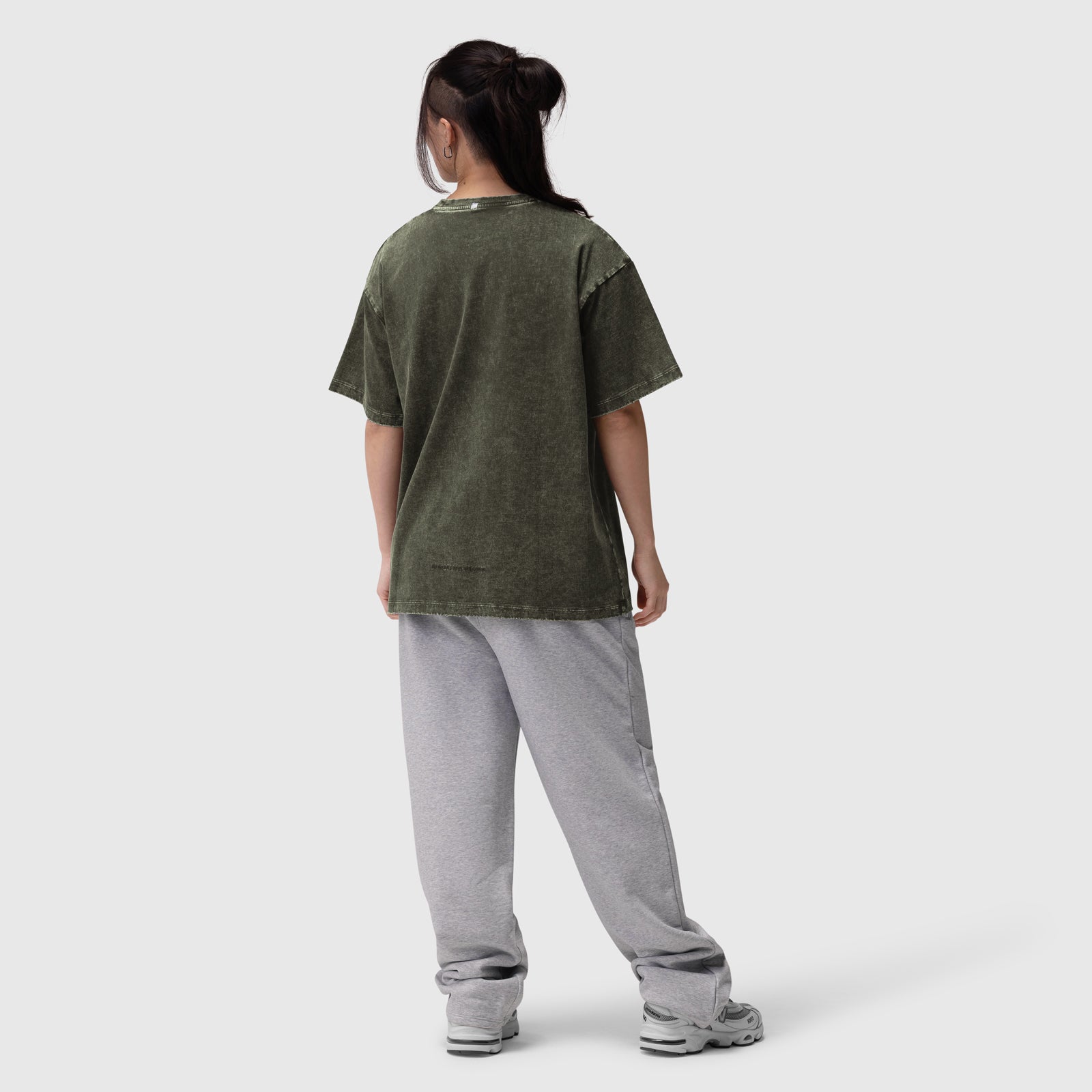 Distressed Relaxed Tee in olive worn with grey joggers, back view