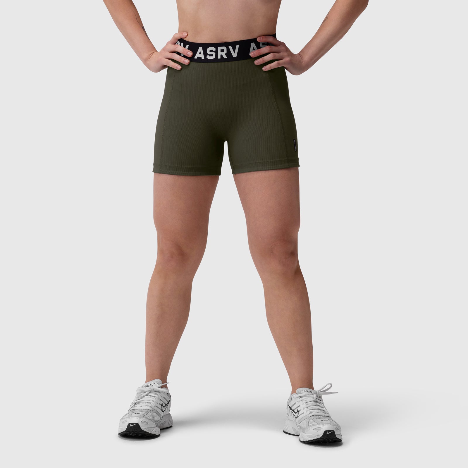 W027 Lycra Ribbed Short in olive, modeled from front with hands on hips