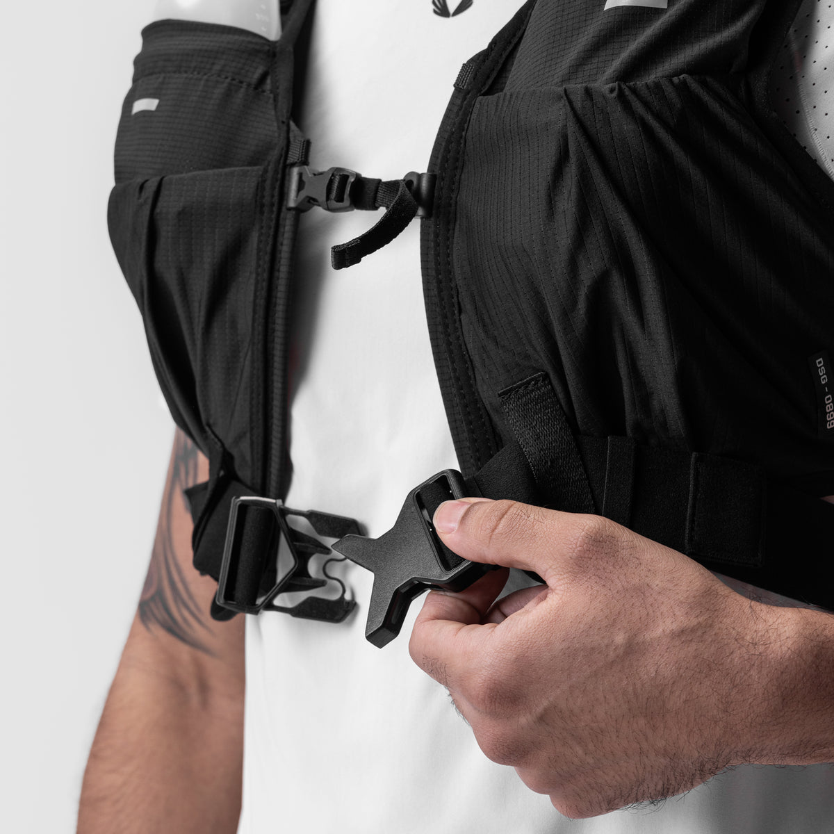 2-in-1 Packable Run Vest in Black, worn and fastened detail closeup