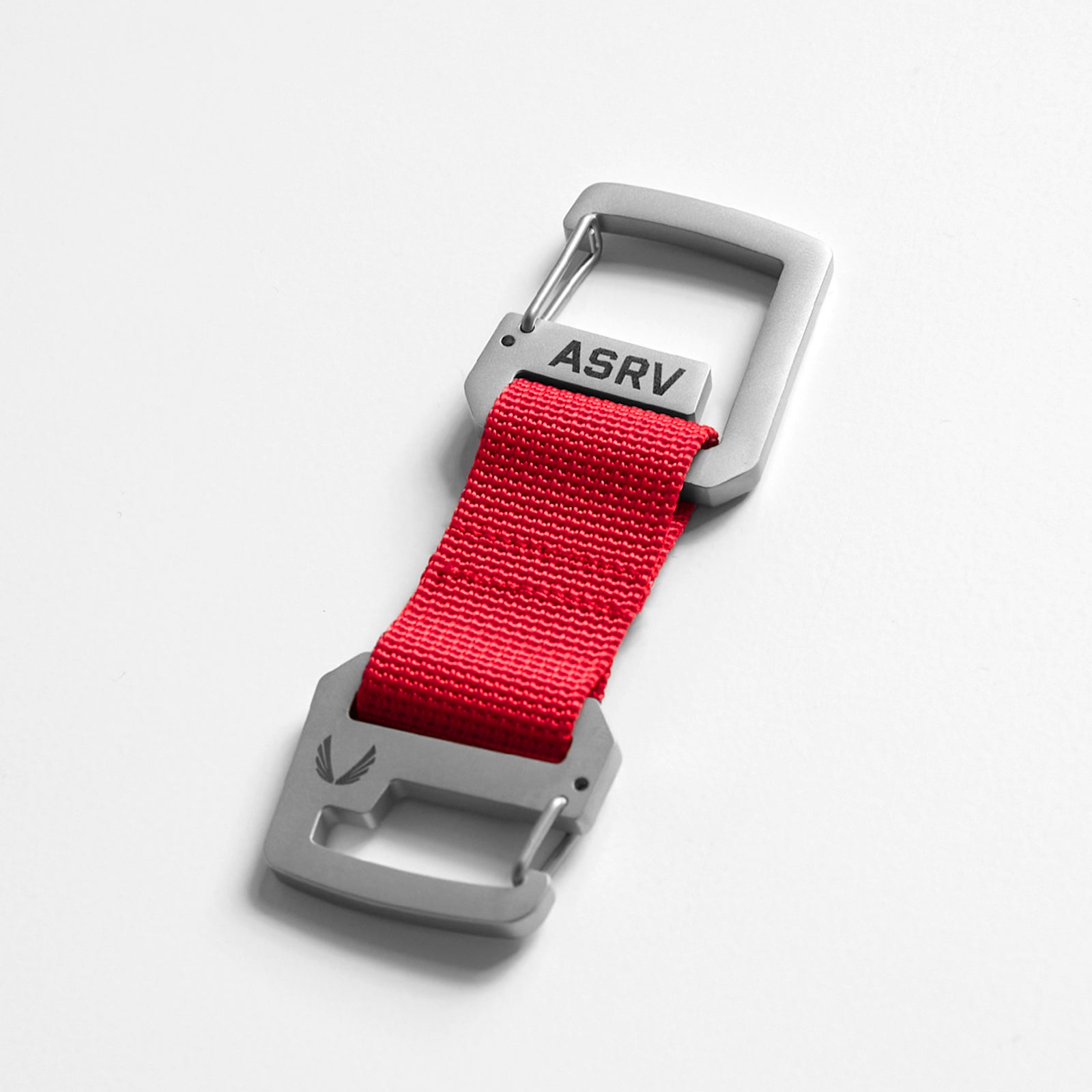 flatlay Double Clip Keychain in stainless steel and red nylon, overhead view
