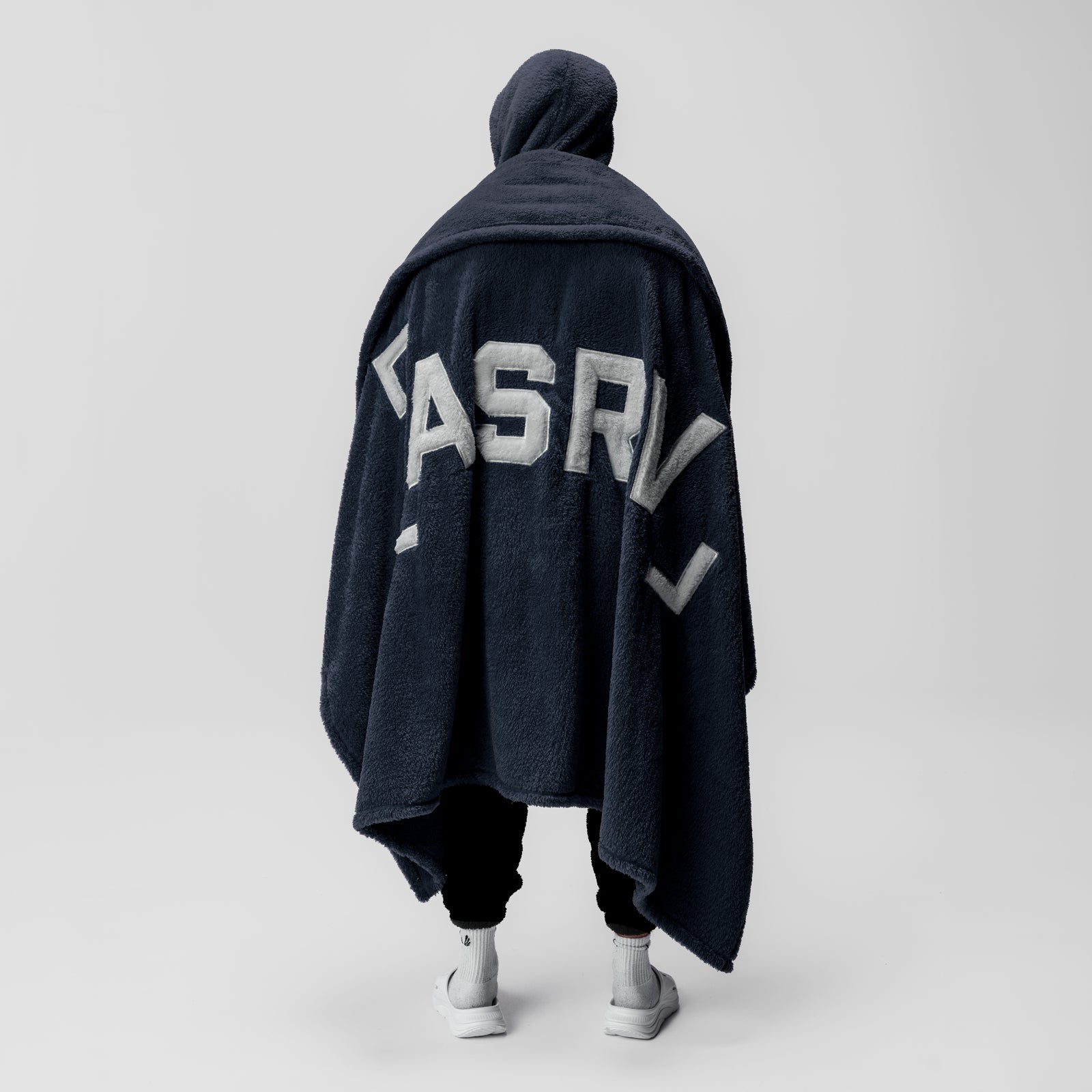 Sherpa Recovery Blanket in navy with white ASRV logo, worn as a cape by model from behind