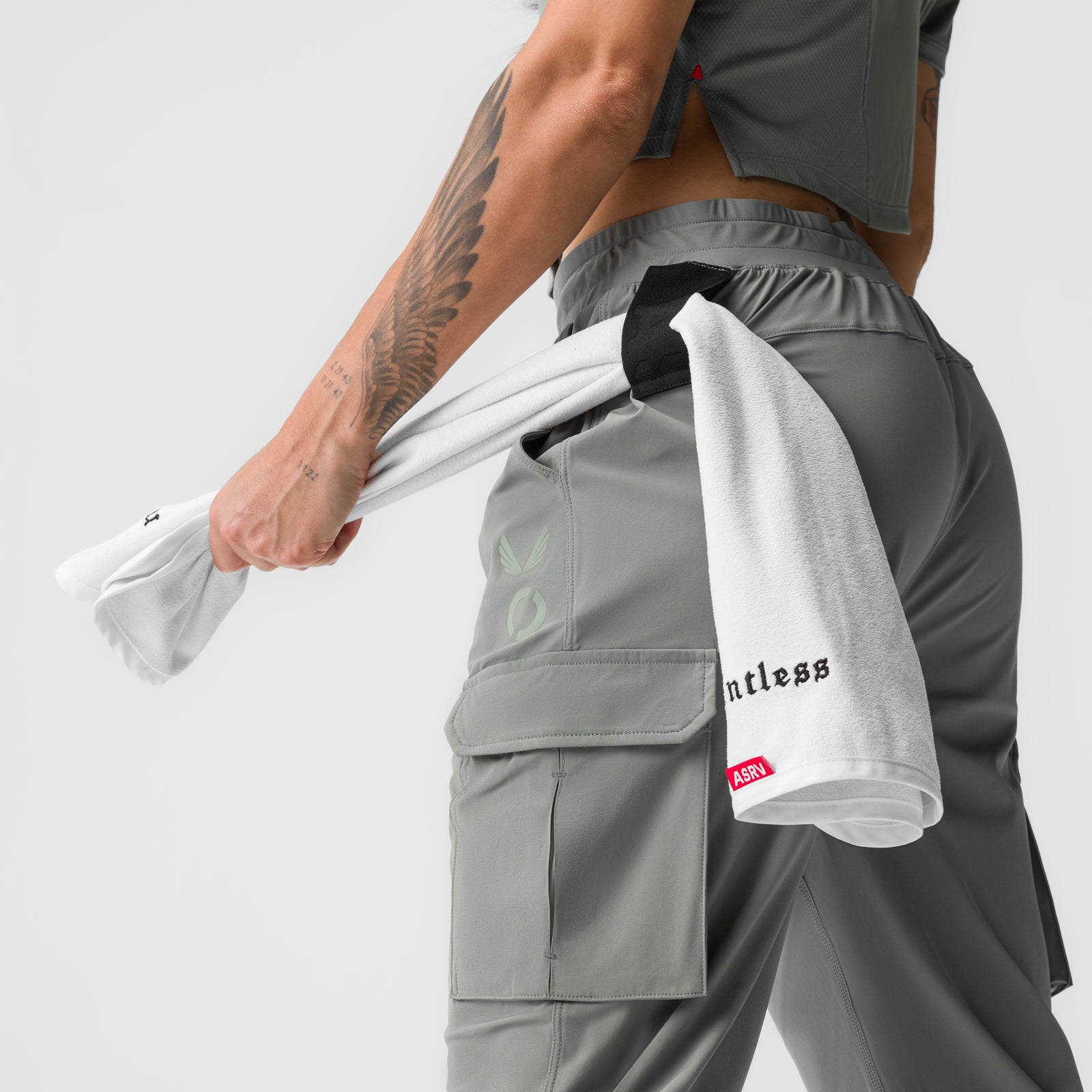 Sage cargo jogger worn by model holding white towel, side view