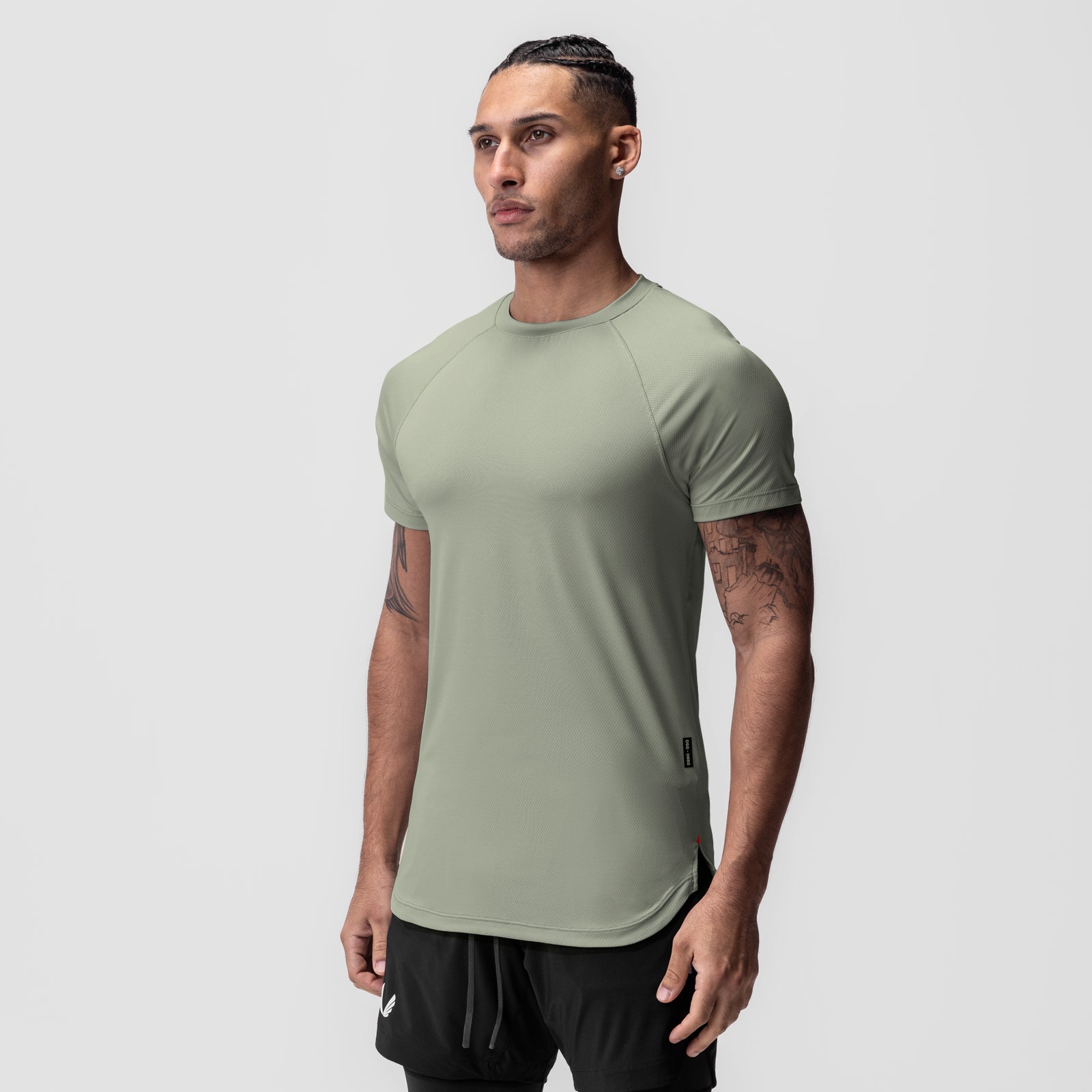 AeroSilver Established Tee in sage, worn by model in three-quarter view