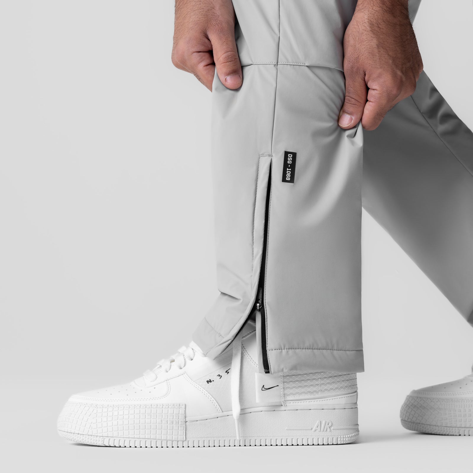 Aerotex™ PrimaLoft® Warm-Up Pant in slate grey worn with white sneakers, side detail view