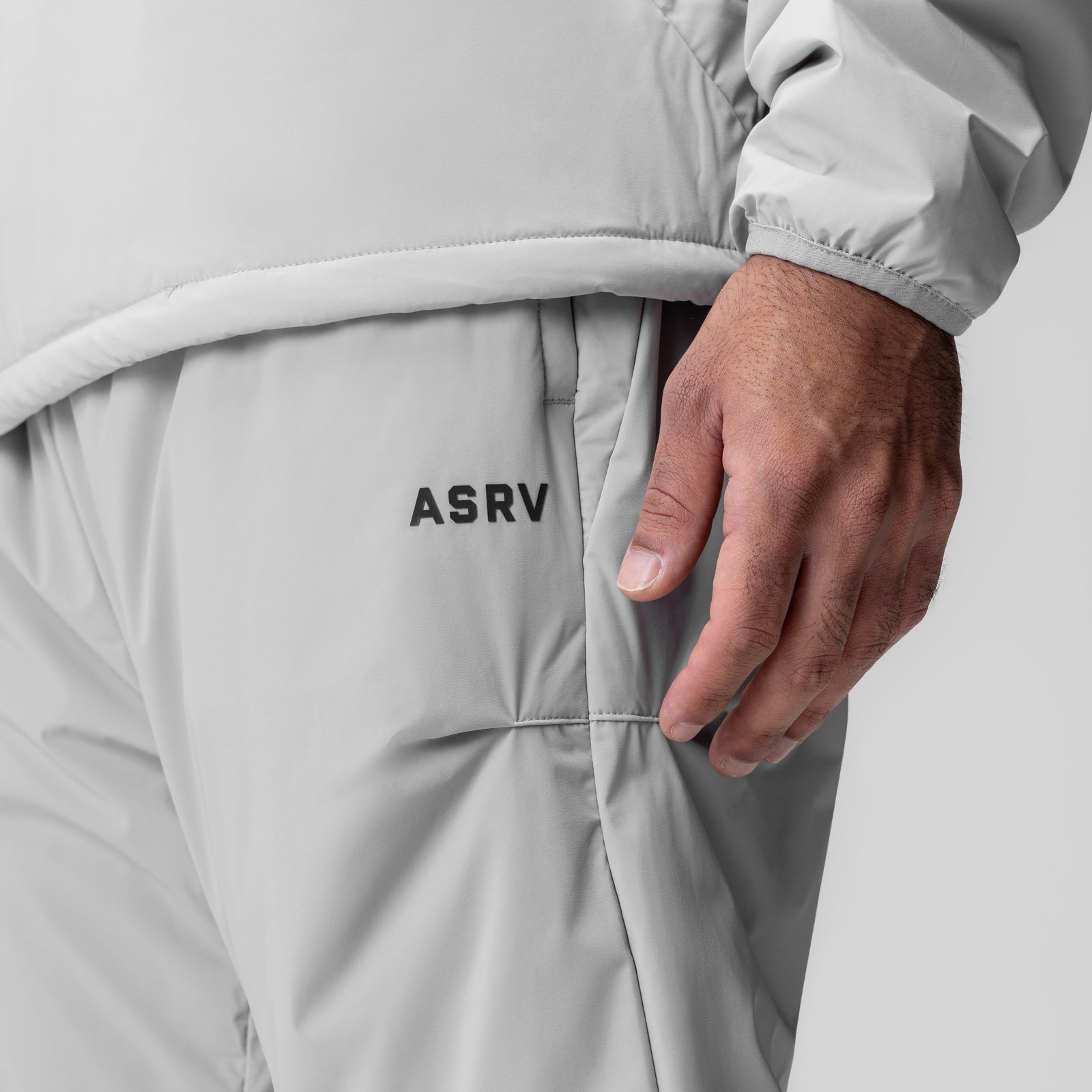 ASRV Aerotex PrimaLoft Warm-Up Pant in slate grey, modeled at waist with hand in pocket