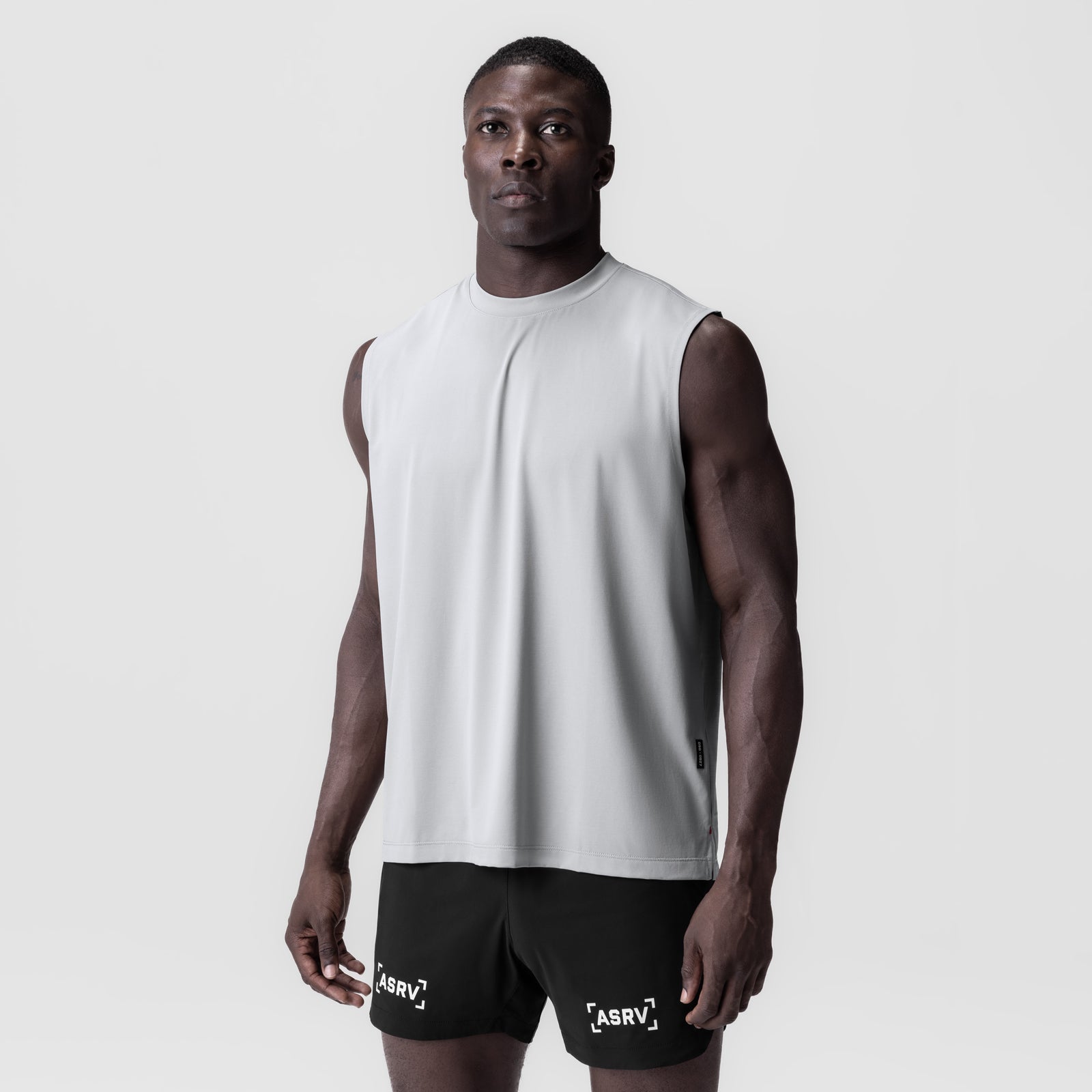 3D-Lite® 2.0 Lycra® Relaxed Cutoff shorts in black, worn with white sleeveless tank