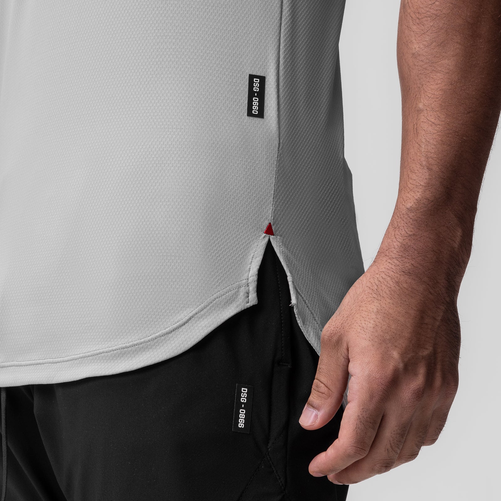 AeroSilver Established Tee in slate grey worn by model, side detail view showing hem and label