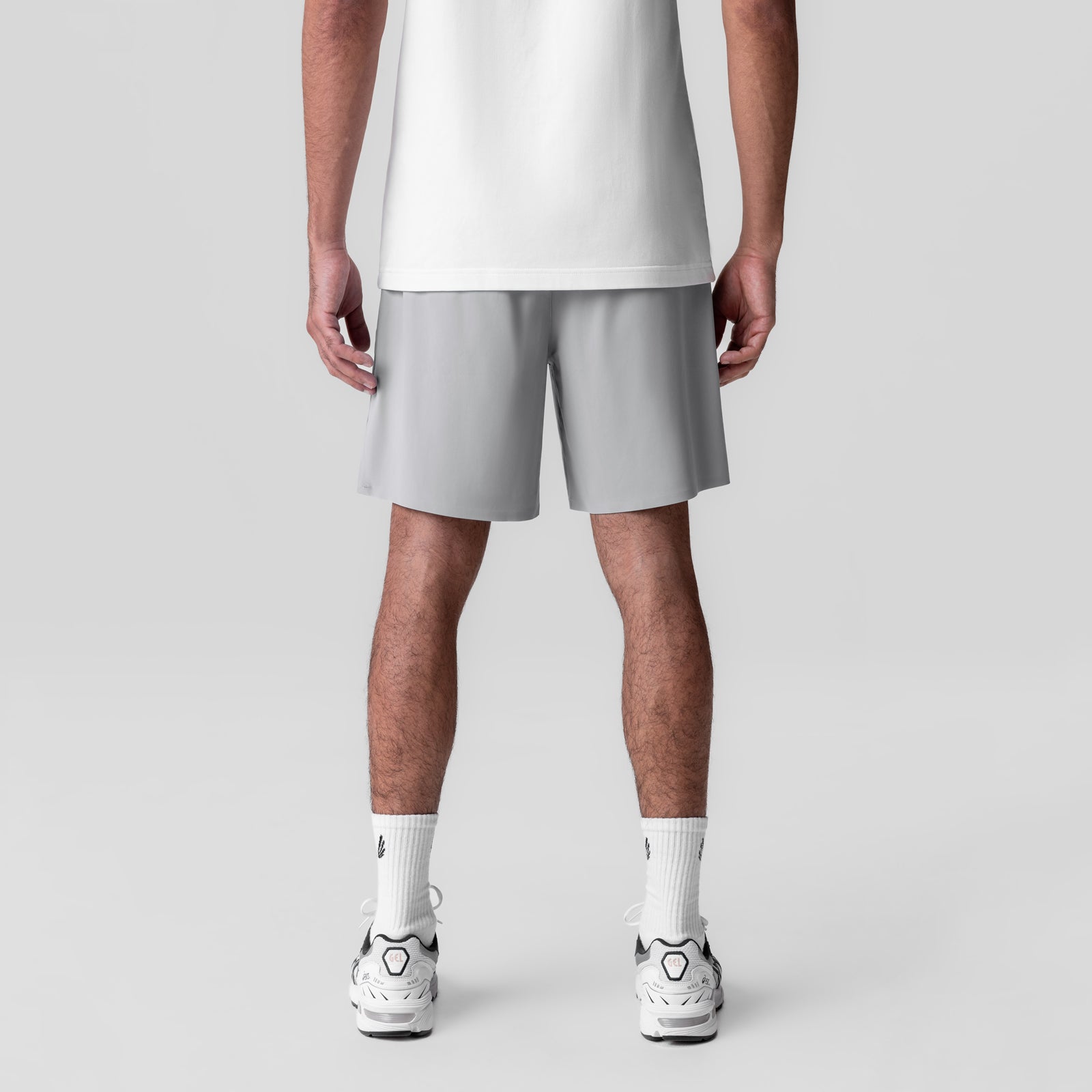 Revolutional Field Short in slate grey, back view on model wearing white tee and white sneakers