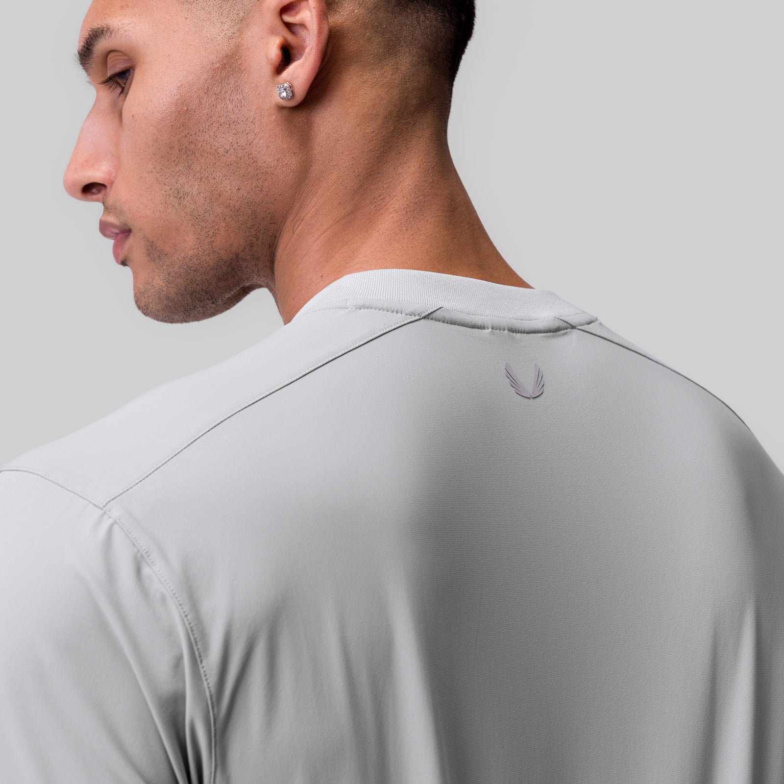 Tetra-Lite Ice Zip Tee in slate grey, worn by model in profile view