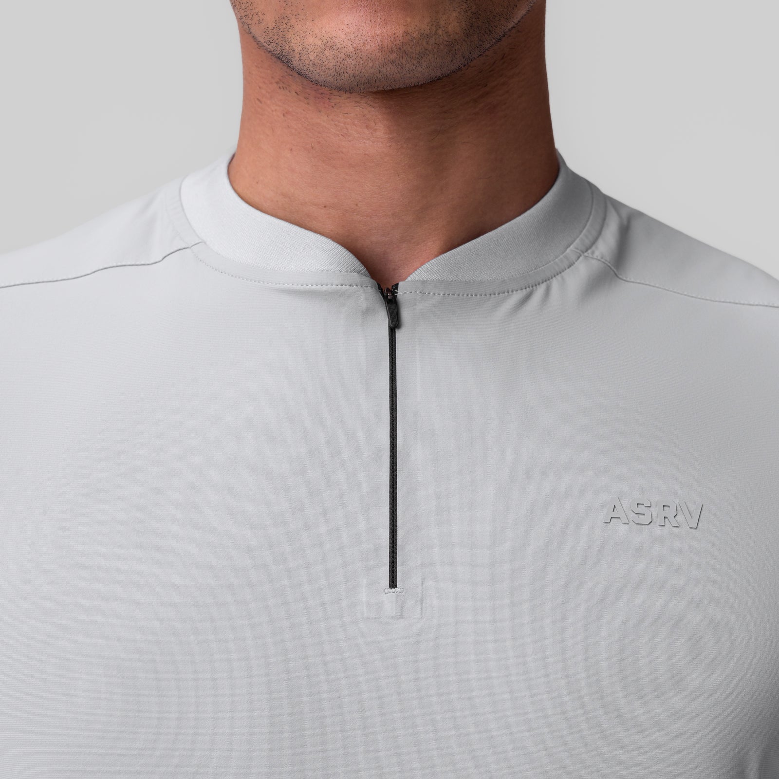 Tetra-Lite Ice Zip Tee in slate grey, worn by model, chest detail view