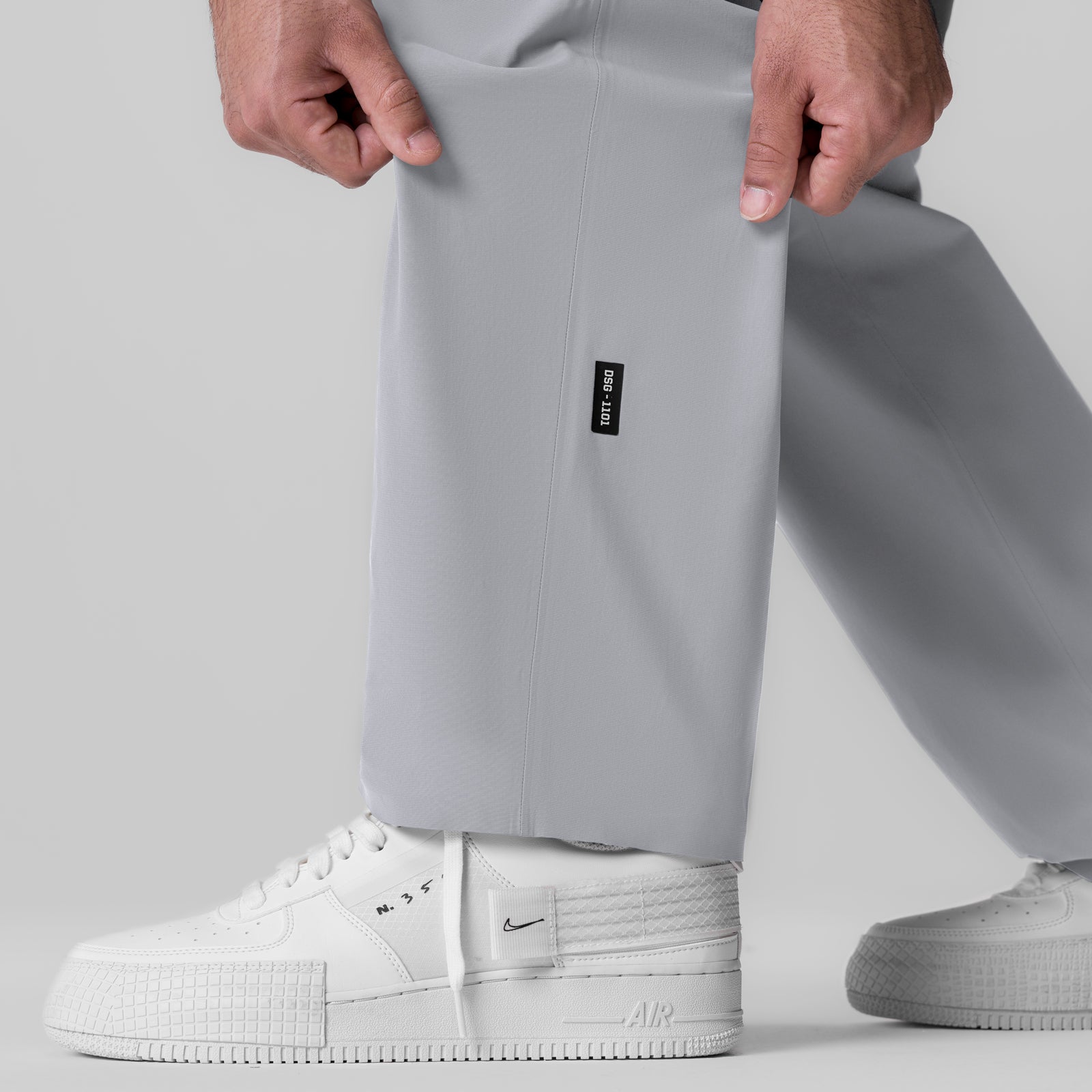 Tetra-Lite Field Pant in slate grey worn with white sneakers, front view