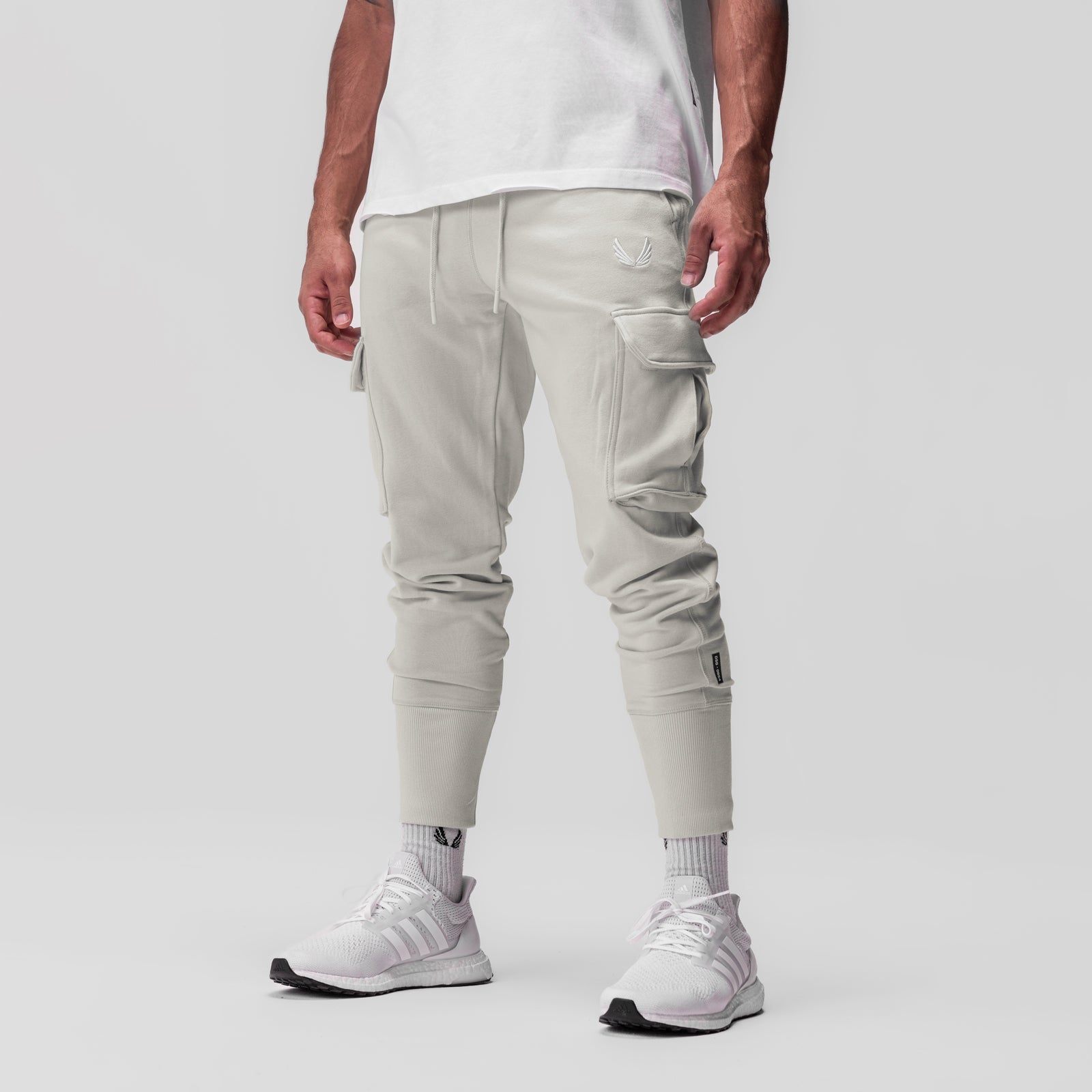 Tech-Terry Cargo High Rib Jogger in stone, modeled from the side, paired with white socks and sneakers