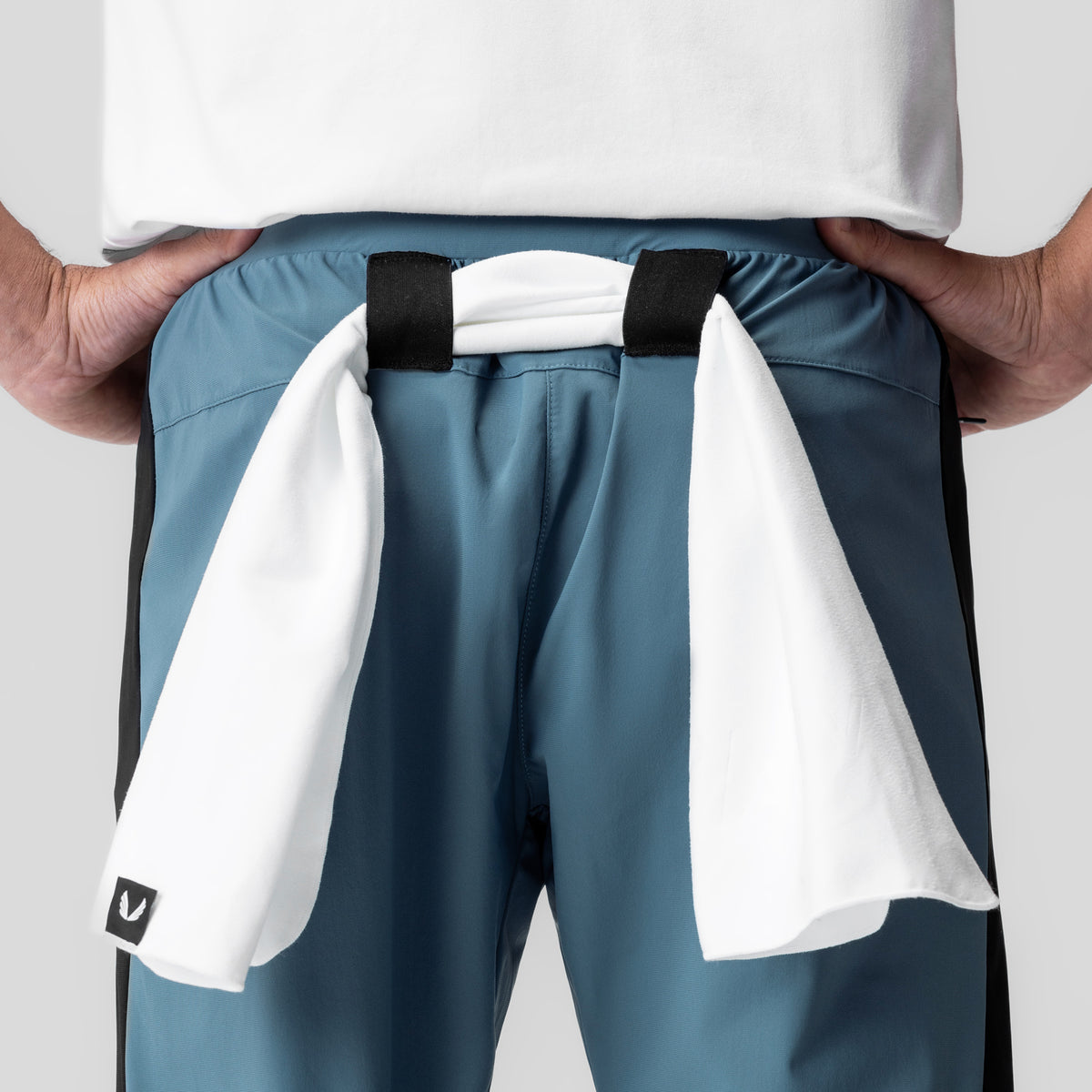 Tetra-Lite Cuffed Training Jogger in storm blue, worn with white towel draped over shoulders