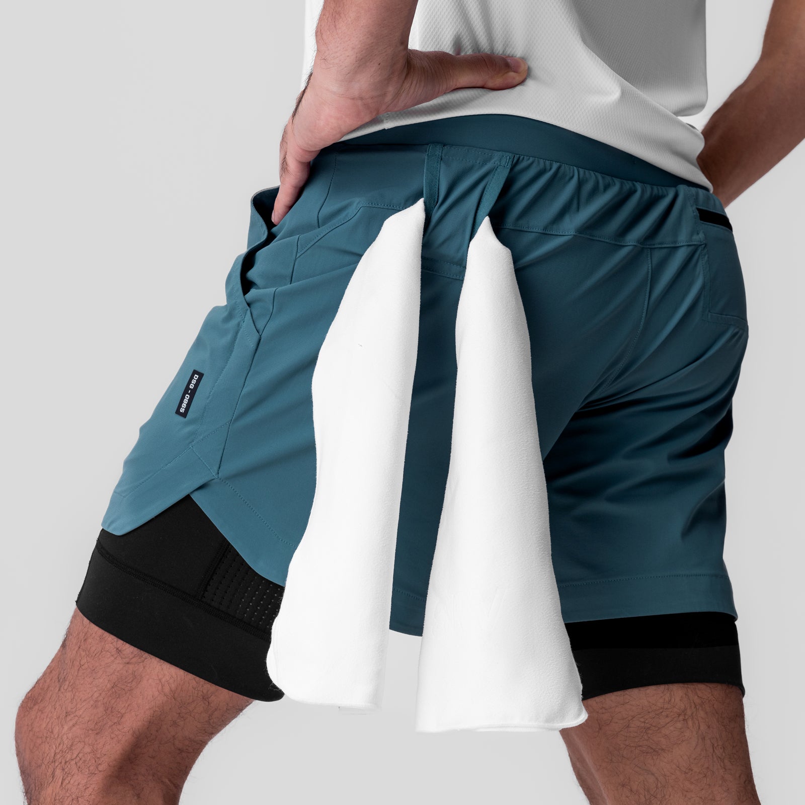 Tetra-Lite 5" Liner Short in Storm/Black, model holding shorts to show internal liner