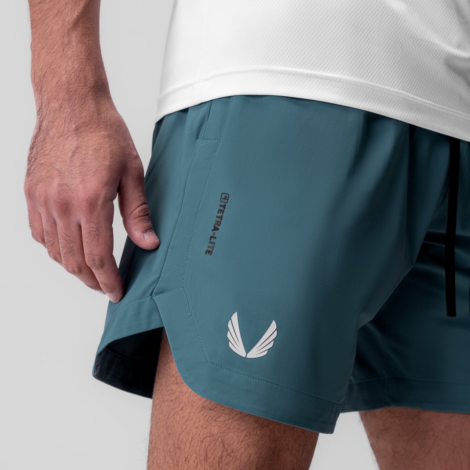 Tetra-Lite 7" Linerless Short in storm blue, modeled on person with hand in pocket