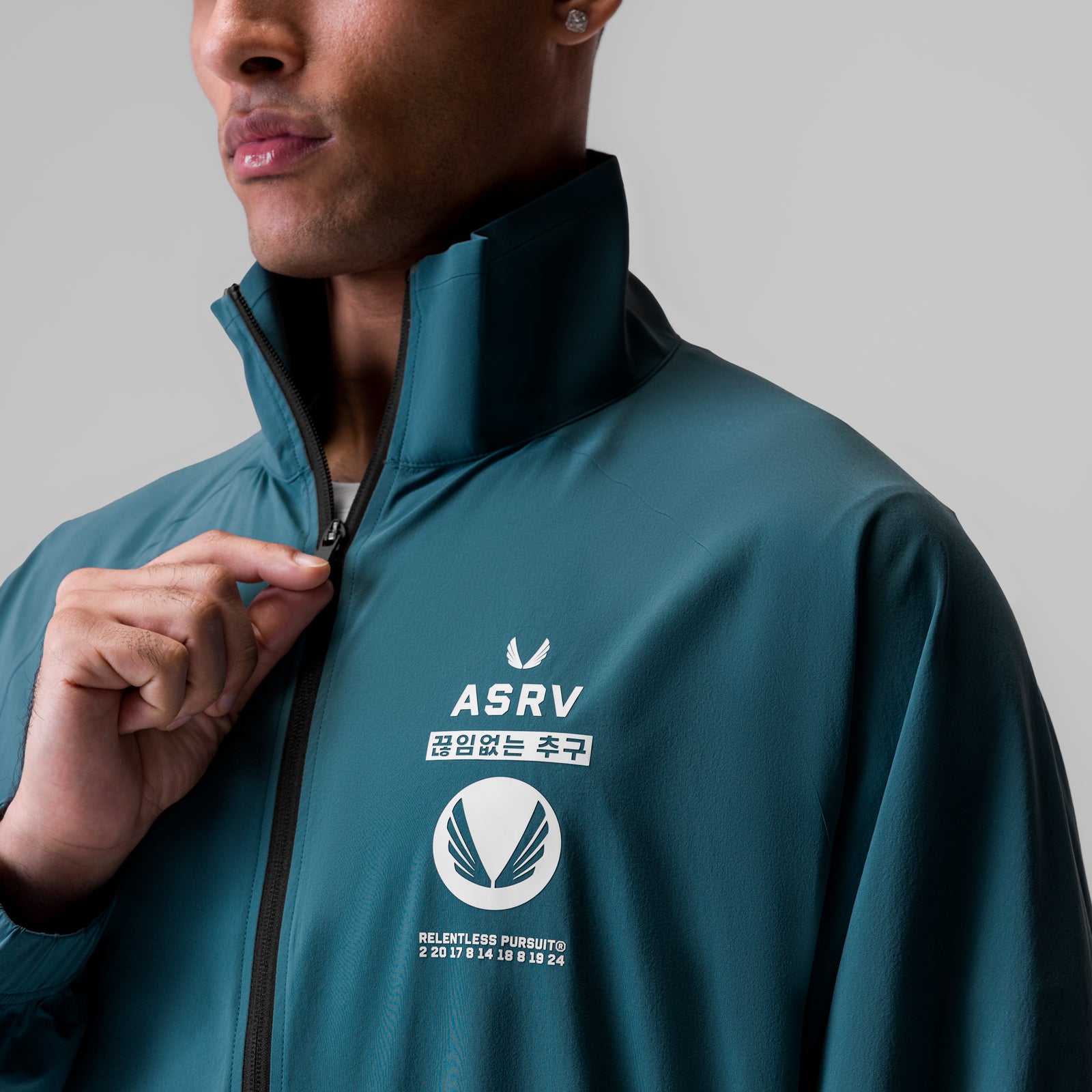 Aerotex™ Track Jacket in storm blue, worn by model holding collar