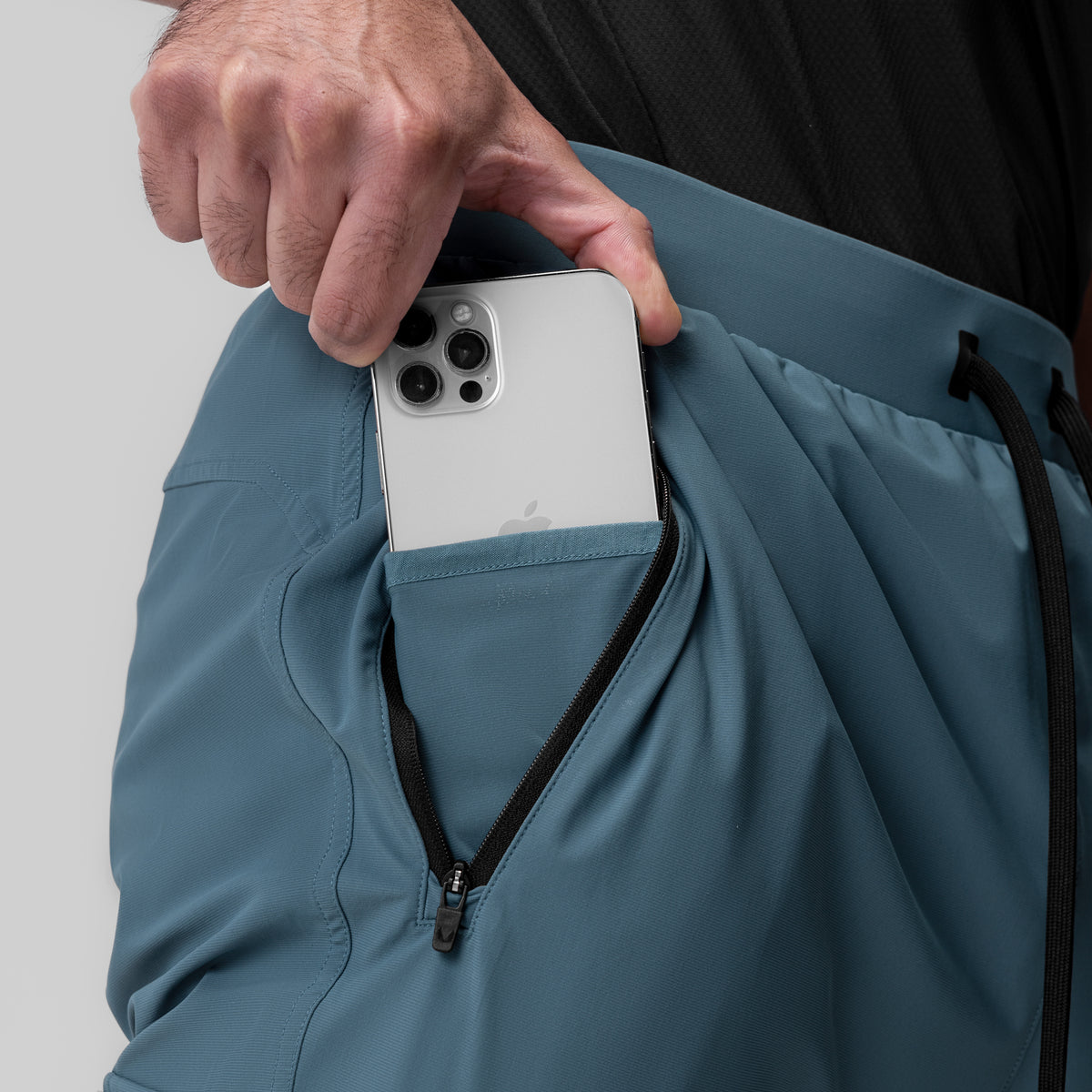 Tetra-Lite® Ice Cargo High Rib Jogger in Storm being held by model, showing pocket detail