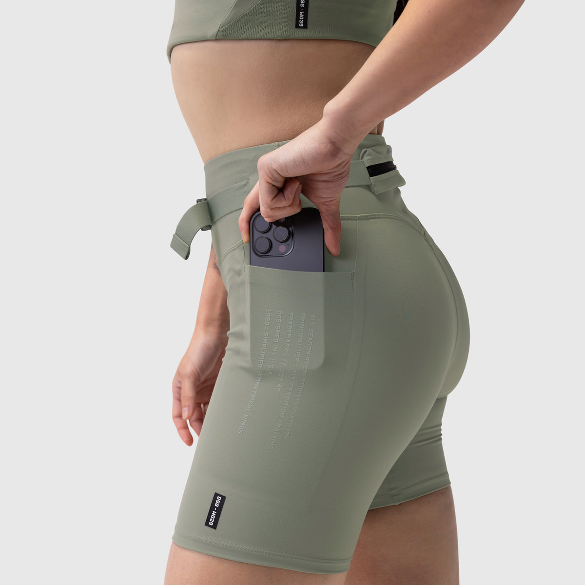 W029 Lycra 3-in-1 Biker Short in sage, model wearing shorts with phone in pocket