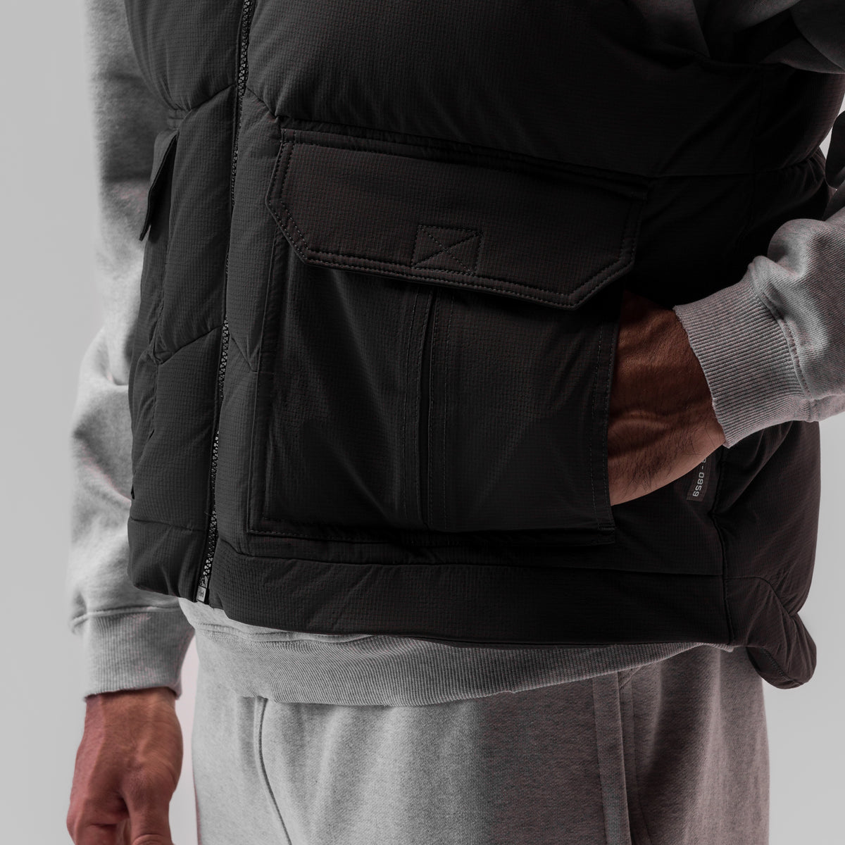 Ripstop Insulated Puffer Gilet in black worn over grey hoodie, side detail view