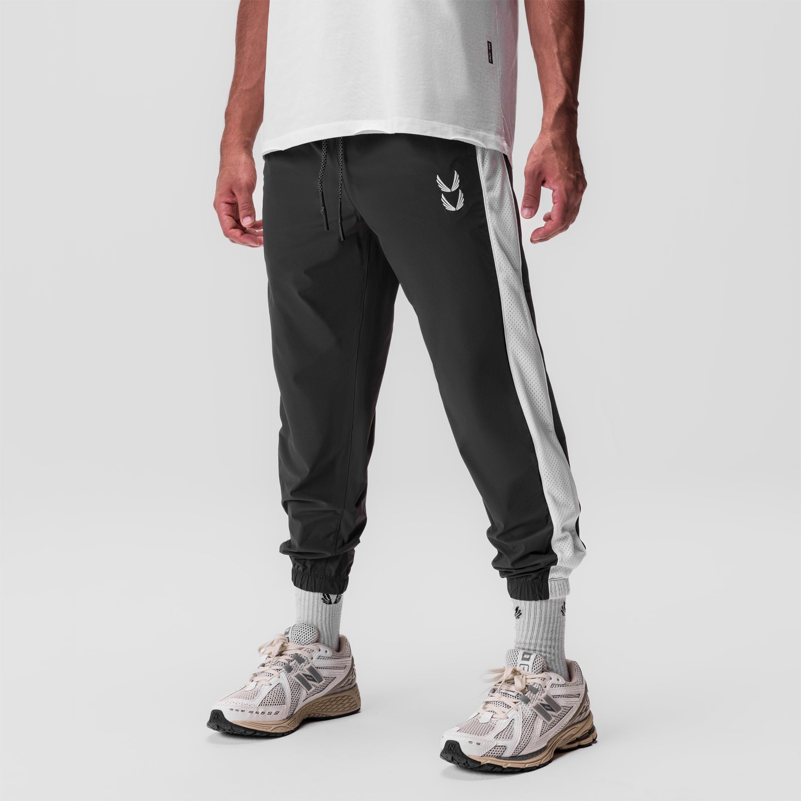 Ripstop Oversized Track Pant in black with grey side stripe, worn with white socks and sneakers
