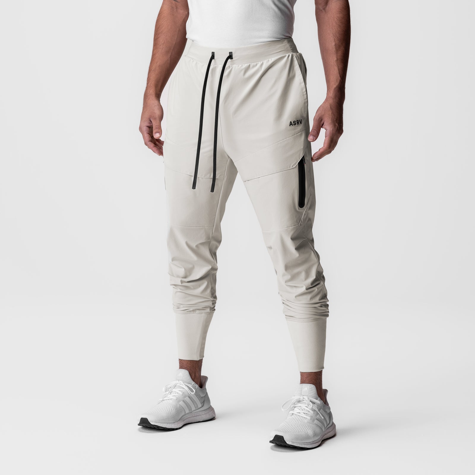 Tetra-Lite Tech High Rib Jogger in stone, worn by model standing against white background