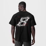 Black Tech Essential Relaxed Tee with blurred graphic design, back view on model