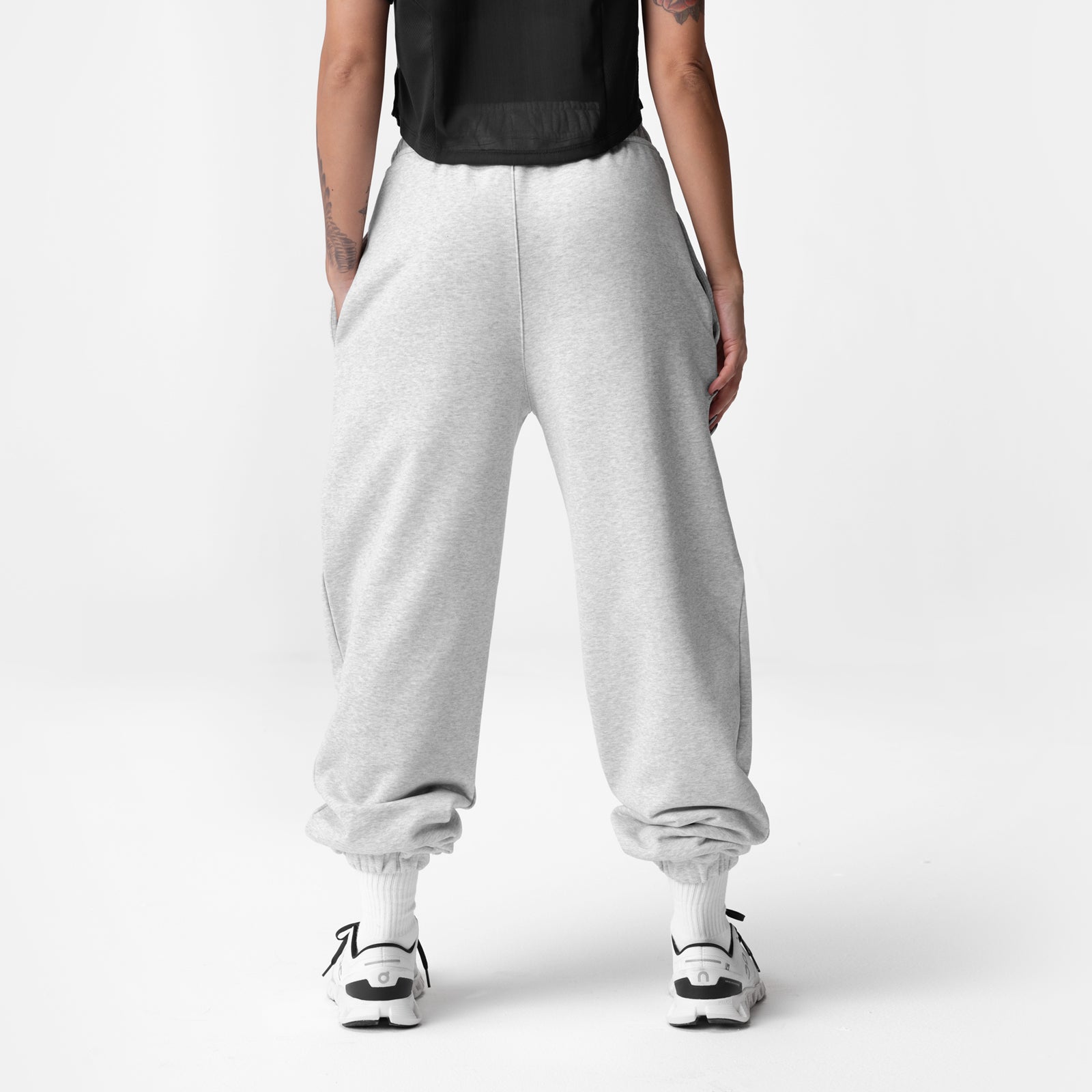 Heather grey oversized jogger in French-Terry fabric, back view on model wearing black top and white sneakers