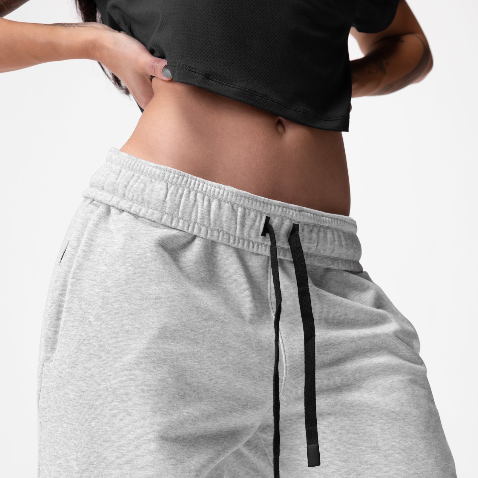 Heather grey French-terry oversized jogger worn by model, front waist detail view