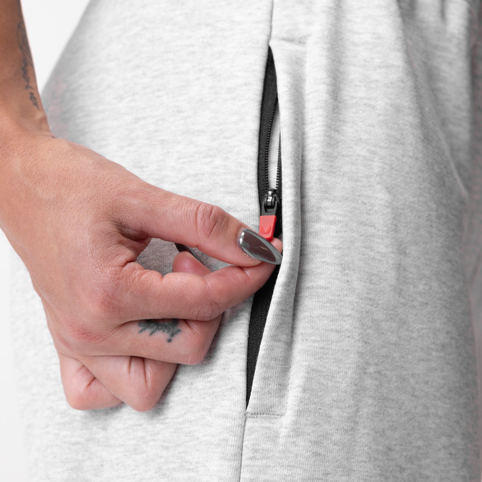 Heather grey French-Terry oversized jogger worn by model, showing zippered side pocket detail